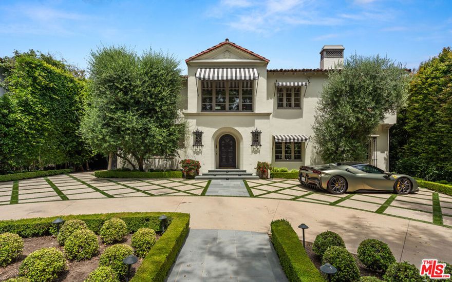 This beautifully renovated 1920s Spanish-style home is set on a sprawling 19,500 square-foot lot in the prestigious Beverly Hills Flats. Blending timeless charm with modern luxury, the residence features six spacious bedrooms, each thoughtfully designed with abundant natural light and elegant finishes.The entertaining areas in the home are adorned with exposed wooden beams, adding warmth and character to spaces designed for gathering. A beautiful loggia off the downstairs entertainment area creates a perfect flow between indoor and outdoor living, ideal for hosting guests or enjoying quiet moments surrounded by nature. The expansive primary suite, serves as a luxurious retreat featuring a large, private deck that overlooks the beautifully landscaped backyard. The suite also includes separate his and hers ensuite bathrooms, complete with high-end fixtures, walk-in closets, and refined finishes, offering an unparalleled sense of comfort and privacy. A detached guest house further enhances the property, offering a guest room, a gym, and a three-car garage. The expansive, private backyard is a lush oasis, complete with mature trees and ample space for outdoor dining and relaxation. Located in the coveted Beverly Hills Flats, this home provides the perfect balance of serene privacy and proximity to world-class shopping, dining, and entertainment.