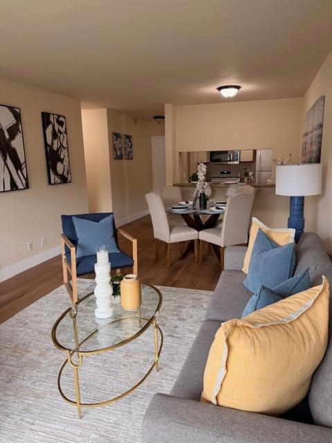 Welcome to this charming top floor 2 bedroom, 1-bathroom residence. This 817 sq ft home offers a practical and inviting living space. The kitchen is well-equipped with modern amenities, including a dishwasher, new built-in microwave, new electric oven range, and refrigerator, making meal preparation a breeze. The living-room is seamlessly integrated with the kitchen, providing a spacious, open area for relaxation and entertainment. Both bedrooms each feature walk-in closets offering ample wardrobe & storage space and private decks. The wood laminate flooring throughout the home is designed for comfort and ease of maintenance. The electric marble-faced fireplace adds a warm & cozy touch to the living area. New double pane patio sliding glass doors. Residents can enjoy a range of community amenities, including a fenced, heated pool with a spa, and sauna, as well as facilities like a gym, kennel/dog run, and basketball courts. Community laundry facilities are available for convenience. This home is ideal for those seeking a vibrant community with excellent amenities. 1st Open House: Sunday, Oct 12 from 1-3pm