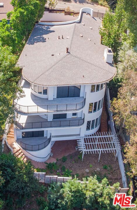 Get the best deal per square foot in the area! Discover breathtaking views in this stunning 3-level home, nestled in a quiet Cul-de-Sac in Studio City s hills. This exceptional residence features 5 bedrooms, 5.5 bathrooms, and 4 expansive decks showcasing magnificent San Fernando Valley vistas. The home s modern luxury design seamlessly blends comfort and style. Inside, you'll find a bright, open floor plan with elegant flooring, recessed lighting, and custom fixtures throughout. The entry level boasts a spacious living and dining area, a stylish kitchen, and two balconies revealing the stunning SFV panorama. The chef s kitchen is perfect for entertaining and awaiting your appliances, featuring abundant cabinetry, an island, breakfast bar, and convenient access to the 2-car garage. On the middle floor, enjoy a grand master suite with a cozy sitting area, a private balcony with remarkable views, and a luxurious master bath with a soaking tub and shower. An extra-large walk-in closet completes the master suite, and an adjacent bedroom with a bath offers versatility as an office or nursery. The lower level is dedicated to two additional bedrooms, three full baths, and a spacious family room with a wet bar and balcony. The laundry room is conveniently located on this floor. Each level of the home includes its own balcony, and separate A/C and heating zones ensure comfort throughout. Outside, enjoy the tranquility provided by numerous trees and golden days on the balconies. Located just minutes from fine dining, beaches, Studio City attractions, and the acclaimed Carpenter School, with easy access to Hollywood via back roads or the freeway. This immaculate property offers a peaceful retreat in one of LA's most desirable neighborhoods. Act quickly this exceptional home won t last long. Access is via stairs from the street, with a 2-car garage and additional driveway parking spaces.
