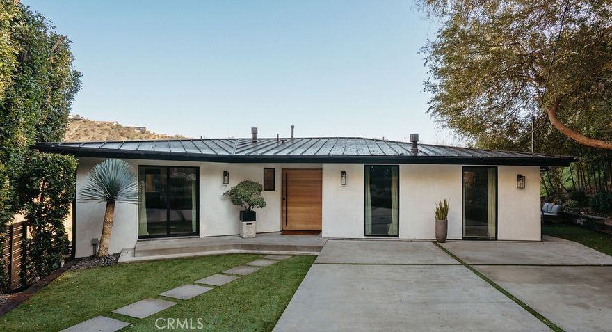 Perched in the heart of the Laurel Canyon, this fully reimagined modern residence offers refined architectural design and seamless indoor-outdoor living in one of Los Angeles’ most desirable enclaves. Enter through a private gated drive that opens to a welcoming front yard, expansive terrace, and driveway - creating a peaceful sense of arrival and privacy from the moment you enter.

Inside, a light-filled open-concept layout unfolds, connecting the living room, dining area, and kitchen in a way that feels both intentional and calming. Wood floors, soft tones, and thoughtful design details set a tranquil atmosphere throughout. Large glass sliding doors extend the living space to a private balcony, framing canyon views while allowing natural light and cool hillside air to flow effortlessly through the home.

The kitchen is a striking yet understated focal point, featuring a sleek island, Miele appliances, modern cabinetry, and finishes that balance warmth with contemporary style - ideal for both everyday living and quiet moments of gathering. Each bedroom offers a serene retreat, complete with its own en-suite bath, creating a spa-like sense of comfort and privacy throughout the home.

Surrounded by nature and elevated above the city, this residence feels intentionally designed for restoration and balance. Every space has been curated to feel grounded, calm, and connected to its surroundings - offering a rare sense of peace while remaining just minutes from Hollywood, the Sunset Strip, and the Valley. Additional features include a Savant smart home system, security cameras, living room theatre speakers, and two fireplaces, seamlessly blending comfort, technology, and design. A true hillside sanctuary where modern architecture meets mindful living.