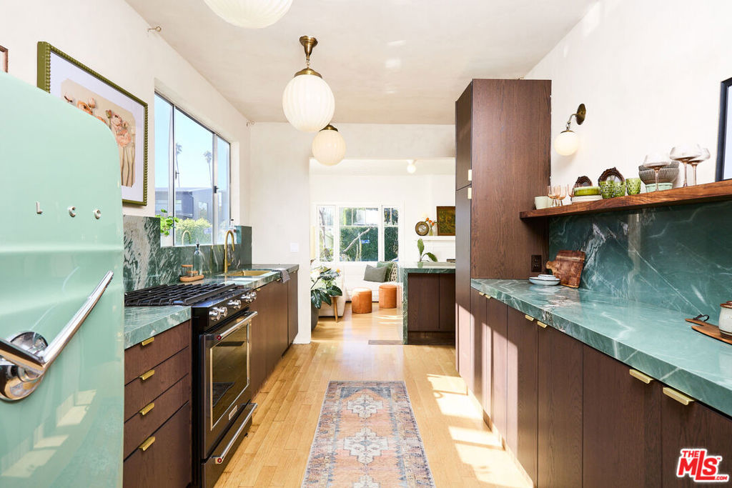 Welcome to your own private oasis in the heart of Venice Beach, featuring a beautifully updated main house and detached guest house just a short stroll from the buzzing energy of Abbot Kinney. This one-of-a-kind property blends timeless charm with stylish modern updatesperfect for those looking to live, work, and relax in one of LA's most iconic neighborhoods.The landscaped main house offers three bright bedrooms and two full bathrooms, plus a lofted bedroom accessed by a statement staircaseideal as a creative space, guest room, or home office. The newly renovated kitchen is a showstopper, with custom cabinetry, quartz countertops, and designer lighting that elevates the entire home.Enjoy ultimate privacy in the lush yard with mature landscaping, only one direct neighbor, and a peaceful court street on the other side. Original character details, including a vintage fireplace, add warmth and soul throughout.Tucked away in the back, the detached guest house with a full bathroom offers endless flexibilityguest suite, studio, or potential rental income. With alley access and private parking, this is Venice living at its absolute best.Don't miss this rare gemfull of personality, style, and prime walkability!