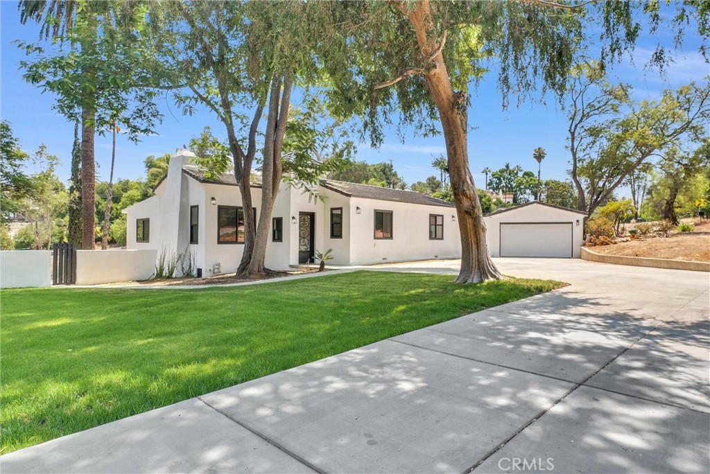 Stunning Renovated Estate with Guest House/ADU, Pool, & Pool House
Welcome to your dream home! This beautifully renovated estate in one of Riverside’s most sought-after neighborhoods offers luxury living with room to relax, entertain, and grow. Sitting on a generous 0.8-acre lot, this turnkey property features a fully upgraded 4-bedroom, 3-bath main house, a spacious 1-bedroom, 1-bath guest house with private laundry, in-ground pool and a charming pool house complete with a cozy fireplace that can be converted to a 2nd guest house/ ADU.
Step into the 1,976 sq. ft. main residence, where modern elegance meets everyday comfort. The heart of the home is the gourmet kitchen, outfitted with high-end stainless steel appliances, custom cabinetry, quartz countertops, and a sleek island — perfect for hosting or enjoying a quiet morning coffee. The open floor plan seamlessly connects the kitchen to the living and dining areas, filled with natural light from brand-new windows and finished with designer flooring and fresh paint throughout.
Retreat to beautifully upgraded bathrooms with contemporary finishes, and enjoy peace of mind with major updates including a new roof, drywall, windows, flooring, and interior/exterior paint. An automatic sprinkler system keeps the landscaping lush year-round.
The detached 550 sq. ft. guest house is ideal for multigenerational living, rental income, or extended stays, offering complete privacy and its own laundry area. The pool house, featuring a fireplace, adds a perfect bonus space for entertaining or unwinding after a swim.
Outside, the sparkling swimming pool sets the scene for summer fun, all framed by the large backyard that offers endless possibilities for outdoor living and expansion.
Located just minutes from Downtown Riverside, UC Riverside, and California Baptist University, this home combines the convenience of city access with the tranquility of a well-established neighborhood.