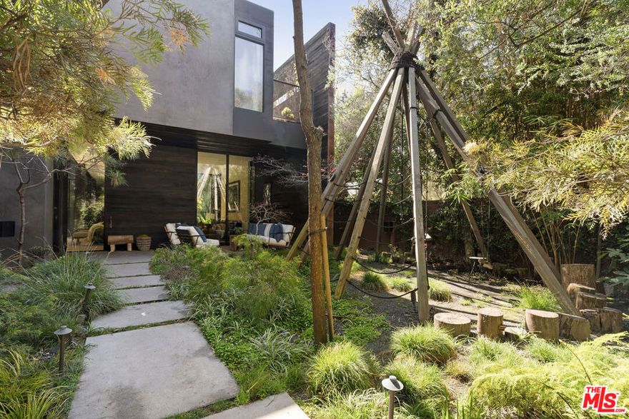 Exceptional Venice architectural masterpiece by Marmol-Radziner! This magnificent custom-built property blends world-class-resort-caliber luxury and high-end finishes with warm and alluring design that enhances the verdant natural setting. Walls of glass open to create a sprawling open floor plan that seamlessly flows from the tasteful interiors to the relaxing, lushly landscaped grounds. Recently refinished, the first level has natural stone floors with radiant heat throughout and offers the refined living room, dramatic dining room, sleek wood-clad gourmet eat-in chef's kitchen, pantry, powder room, and laundry room. Upstairs are the 3 bedrooms, including the Zen-like primary retreat which features a private balcony and a dreamy wood-paneled bathroom with a sunken tub and rainfall shower. The spectacular outdoor spaces offer even more amenities, including heated jet pool, hot tub, outdoor shower, fire pit, and custom wood-burning grill built by M/R and Grillworks. Unbeatable Venice location, just a couple blocks from the trendiest shops, galleries, and restaurants on Abbot Kinney Blvd, and just a few minutes from the beach! Gated for privacy and security, this special property is a gorgeous escape in the heart of Venice that will recharge and inspire your creative mind.