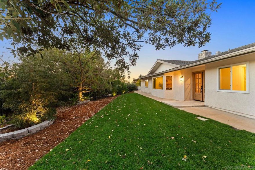 Welcome to this beautifully appointed single-level home in the coveted Valle Verde Estates of Poway. Situated on over a half acre, the property sits gracefully above the street, offering exceptional privacy and tranquility. Step inside to a bright, open interior where clean lines, designer finishes, and natural light define the space. The foyer opens to a formal living room featuring a stunning modern fireplace, wide-plank flooring, and expansive windows that frame views of the surrounding landscape. Every detail has been thoughtfully curated to balance contemporary sophistication with everyday livability, creating a home that feels both elegant and effortlessly comfortable. At the heart of the home is a chef’s kitchen that perfectly blends style and functionality, featuring gorgeous island, custom cabinetry, and a seamless connection to the dining and family areas—ideal for both everyday living and entertaining. The adjoining family room includes a custom bar and sliding doors that open to a spacious patio, creating effortless indoor-outdoor flow.  The thoughtful floor plan includes two primary suites, ideal for multigenerational living or hosting guests. The main suite is a true sanctuary with a large walk-in closet and a luxurious en-suite featuring dual vanities, and a stunning shower. Additional highlights include a large laundry room, oversized garage, and ample guest parking. Located within the award-winning Poway Unified School District and just minutes from trails, shopping, and dining, this home embodies the perfect blend of modern comfort and timeless style!