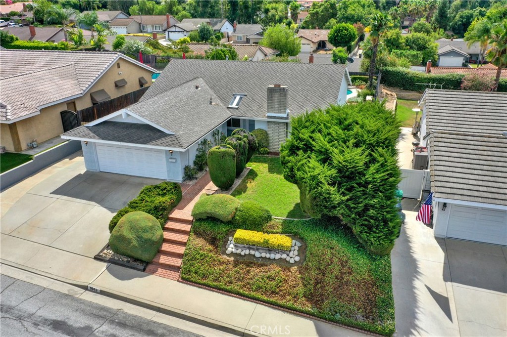 Welcome to this charming single-level home at 1646 Calle Miradero, offering 4 bedrooms and 2 bathrooms across 1,635 sq. ft. of living space.
Step inside to a spacious living room with a cozy fireplace, perfect for gatherings. The entryway features tile flooring, and the open floor plan continues with a large family room boasting high ceilings and abundant natural light. The family room flows seamlessly into the open kitchen and casual dining area, creating a warm and inviting space for everyday living.
Down the hall are two comfortable guest bedrooms, a full guest bathroom with shower and tub, and a designated laundry room. The private primary suite sits on the opposite side of the home, featuring expansive closet space, ample storage, tile counters in the bathroom, and direct access to the backyard through a sliding glass door.
The backyard is designed for both relaxation and entertainment, complete with a sparkling pool and spa, covered patio, built-in BBQ, drought-tolerant landscaping, and automatic sprinklers. On the side yard, you’ll find RV parking for added convenience. The property also includes a two-car garage with plenty of storage.
Ideally located near Via Verde Country Club, Raging Waters, Bonelli Regional Park, and Puddingstone Lake, with easy access to the 10, 57, and 210 freeways, this home offers both comfort and convenience in a highly desirable neighborhood.
Note: The 4th bedroom is currently used as a den/office or dining room, but with a closet already in place, it can easily be converted back into a bedroom.