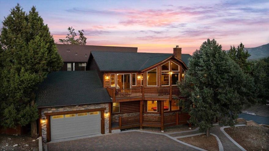Gorgeous Mountain Chalet with mountain and Slope Views! Located in a sought-after neighborhood of beautiful Big Bear Lake just one block from the lake and North Shore Trail--and across from the national forest--this beautifully maintained log-style home blends mountain charm with modern comfort. Enjoy ski slope and water views from the recently refinished exterior and elevated deck. Inside, the dramatic living room features soaring ceilings, an abundance of windows and natural light, a slate fireplace, rich wood flooring, and striking log accents. The spacious kitchen is an entertainer's dream, showcasing granite countertops, custom cabinetry, stainless steel appliances, and an open layout that flows seamlessly into the dining and gathering areas. With five bedrooms--including two luxurious master suites--and four full bathrooms adorned with travertine finishes, there's room for everyone to unwind. A game room complete with pool table and wet bar adds to the home's entertainment appeal. Out back, relax in the hot tub or enjoy the horseshoe pit on the fully fenced back yard. Additional highlights include a paver driveway with ample parking, a desirable corner lot, and proven rental potential as a popular Big Bear Laker vacation home. Lovingly cared for by the sellers, this chalet is a rare find offering year-round enjoyment. Don't miss your chance to own this beloved retreat--schedule your showing today!