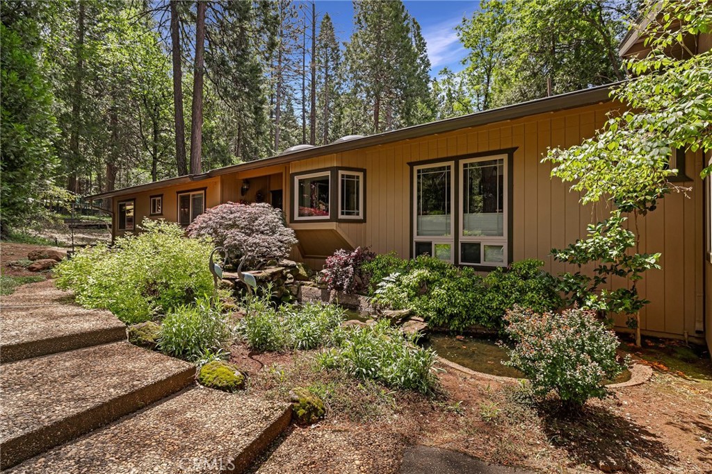 3 BED+DEN, CUSTOM DESIGNED, 1-OWNER HOME has been impeccably kept & beautifully upgraded throughout the years! Exterior improvements include a NEW ROOF (2022), FRESH PAINT (2023), LEAF-GUARD GUTTERS, 3-foot extended roof overhangs and a 10x12 storage shed. Inside, the home is rich with custom details: TRAVERTINE STONE flooring in the entry and kitchen, BRAZILIAN CHERRY HARDWOOD in the living room, AUSTRALIAN CYPRESS HARDWOOD in the hallway, guest room #2, dining and studio. Vaulted wood & beam ceiling in the living room and large skylight in the entry way brings in beautiful natural light. The remodeled kitchen has tile counters, pull-out cabinets, a garden window, stainless steel appliances—including a glass-top Jenn-Air with grill option—and a coffee counter with elegant glass-faced cabinets. Enjoy thoughtful lighting with recessed fixtures, ceiling fans and a stunning custom chandelier in the dining area, updated Milgard windows, custom blinds (including top-down/bottom-up in the dining room), a Lopi fireplace insert with blower and High-Speed Internet! The master bedroom features a private slider to back deck, walk-in closet w/custom organizers. The master bath features a beautifully tiled walk-in shower. The 3 additional guest rooms are currently transitioned to: 1-guest room used for work-out space with access to the guest bath; 2nd room has custom desk built into closet for "his" office/hobby room; 3rd room is "her" office/studio. The laundry room opens to garage offering workbenches, cabinets, and a custom-painted automatic roll-up door. Exterior improvements include a new roof (2022), fresh paint (2023), leaf guard gutters, 3-foot extended roof overhangs and a 10x12 storage shed. This home is nestled on a level & treed, one-acre lot featuring an RV pad with water and power available. Adorned with mature dogwoods, cedars, and pines, the landscaped yard includes a serene entry pond, automatic irrigation, and a charming gazebo on a newer redwood deck—complete with power and propane lines for your BBQ and a fire pit, perfect for outdoor entertaining. Conveniently located just a few miles from shopping, dining, public transportation, and post office. Commuting to the valley is a breeze with a quick and stress-free drive down to the valley. For outdoor enthusiasts there is hiking, biking, camping, fishing, water sports & more! Just minutes to Paradise Lake, DeSabla Lake, Lake Oroville Marina, and the Feather River, plus so much more!!