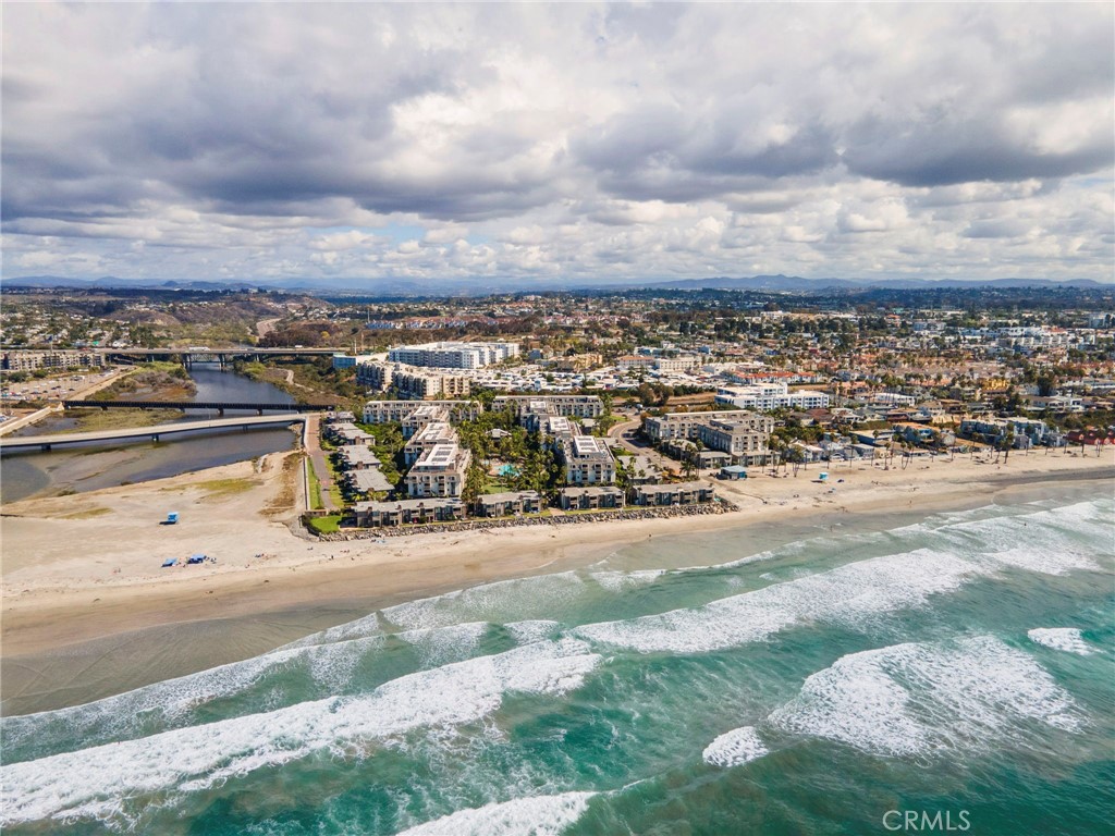 This is the one! Oceanfront resort living in a beautiful and fully furnished 1 bed, 1 bath beach home at North Coast Village. This jewel of a condo perfectly balances elegant touches and relaxing beach furnishings: quartz countertops, stylish lighting, upgraded cabinets, turquoise and ocean blue fabrics and rugs, mirrored walls, and so much more. Relax on the balcony with views of the marina, ocean, and lush tropical landscaping. This condo's location is perfect: close to the assigned covered parking space (with storage) and just steps away from koi ponds, waterfalls, the rec room, game room, world class gym w/sauna, and library. A few more steps and you're at one of 2 heated pools, the adult jacuzzi, family jacuzzi, putting green, and beach access.
This stunningly landscaped Oceanfront property is perfectly situated between the marina and pier in Oceanside- a fun beach community with everything you'd want nearby. Walk to restaurants, shops, the harbor, train station and more.