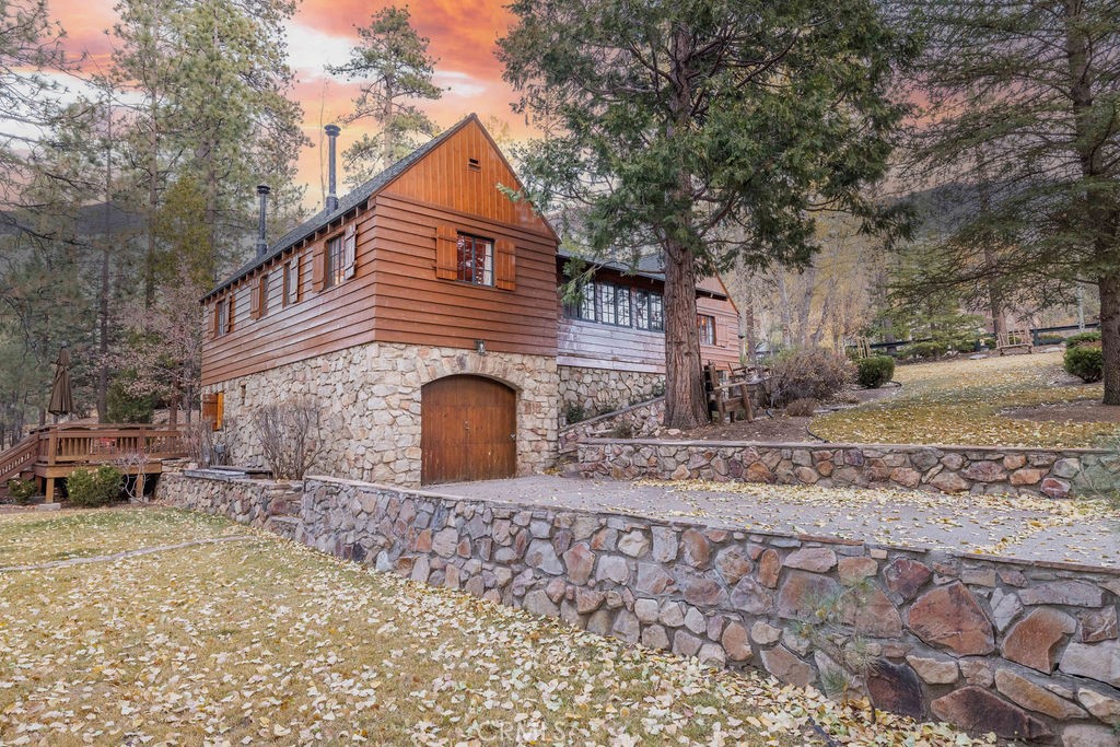 UNIQUE HISTORIC HOME! Built with the finest materials and completely updated HVAC systems retains this home its original mountain charm. Don’t miss the opportunity to own this celebrity owned stunning home. Nestled in a serene and expansive setting, this true mountain estate boasts a huge, picturesque yard perfect for soaking in the natural beauty of the peaceful North Shore. Inside, you'll find 3 cozy bedrooms, 2 baths, and 1,350 square feet of rustic elegance, complete with a log-style interior that evokes the classic "cabin in the woods" experience. Gather around the native stone fireplace on chilly nights with a cup of hot cocoa, or whip up a meal in the kitchen, which features new appliances and gorgeous wood flooring. Step out back to the spacious deck and be captivated by the tranquility of nature. This property truly feels like it has no limits. A rare gem, this mountain retreat is your perfect escape!