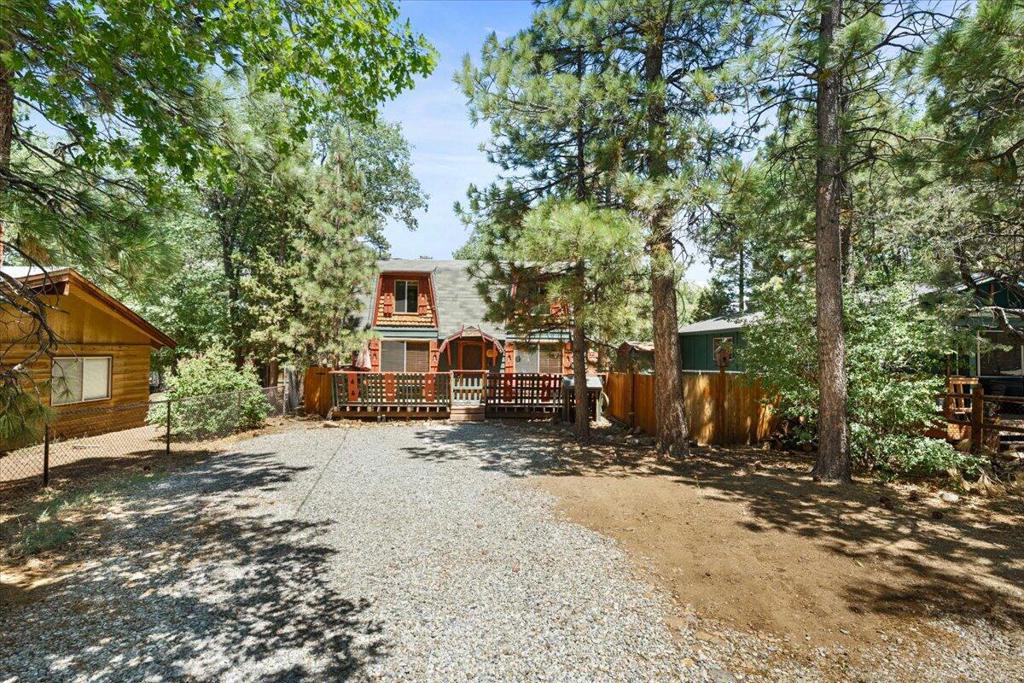 Adorable storybook '' Cabin in the Woods''! This Dutch gambrel design is known for its spacious floorplan. It's set back on a double lot (5000 sqft) with plenty of room to build a garage or store a boat and/or RV.The front and back yard are fenced and gated for privacy. The front and back decks are great to spend time outdoors entertaining, enjoying the firepit for the evening under the stars, or just enjoying the sounds of the trees and birds. It's a perfect mountain getaway for your family and friends or to be used as a short term rental or full time rental. It has been a successful STR in the past but has been used for a full time rental recently for a member of the family. This cabin has that ''cozy vintage mountain cabin feel'' that is apparent as soon as you walk in!