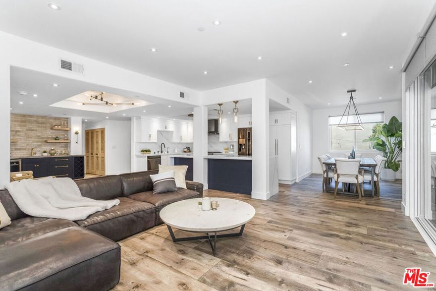 Experience the epitome of luxury living in this stunning condo in prime Sherman Oaks, just a 5-minute stroll to Petit Trois, Sweet Butter Kitchen, Club Pilates, and all the great shopping of Ventura Blvd. This is truly a unique opportunity to live in one of the most stylish condos in Sherman Oaks. This bright and spacious home offers 2 bedrooms, each with its own designer bath, and a powder room for guests. The entire unit was updated in 2020 using the highest quality materials, including a solid oak front door leading to a breathtaking, modern, and elegant open floor plan with Restoration Hardware lighting throughout. The kitchen is a chef's paradise with custom-designed cabinets, Pental quartz countertops, large island and high-end stainless-steel appliances. The spacious dining room easily accommodates large groups, and the living room features a romantic fireplace and a custom-designed bar with wine fridge. The luxurious primary suite resembles a five-star resort, with two custom closets (one walk-in). The grand primary bath offers 2 rain heads, and handheld showers. The second bedroom has its own private custom bath with satin gold brass faucets. Additional features include laundry room with oversized washer/dryer, recessed lights, new AC, windows with motorized shades and a 50 ft. balcony, ideal for entertaining.  This smart home is equipped with Insteon smart switches, where Nest Thermostat, and TV can be controlled by voice commands. Secured parking with two assigned spaces and additional guest spots. Don't miss this opportunity to live in one of Sherman Oaks best walkable neighborhoods with endless amenities including Whole Foods, Fashion Square Shopping Center, the Sportsmen's Lodge, and easy access to the West Side and 405/101 freeways.