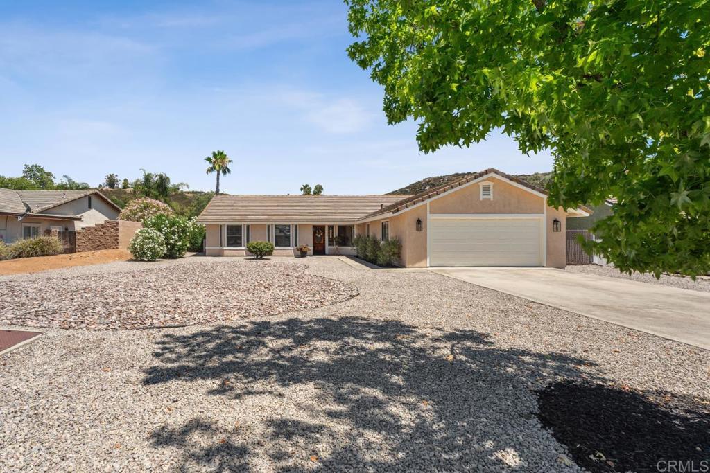 Beautifully maintained and thoughtfully designed, this 3-bedroom, 2-bath home includes a versatile bonus room perfect for an office, guest quarters, or creative space. Set on a spacious, level lot with boundless potential, the property offers ample room for horses, RV parking, an ADU, a pool, or a workshop. Convenient rear access from Gunn Stage Road enhances functionality and flexibility. Step inside to a light and bright interior with vaulted ceilings, updated lighting fixtures throughout, and a flowing floorplan that includes both a spacious living room and a cozy family room with a wood-burning fireplace. The kitchen has been thoughtfully upgraded with new quartz countertops, offering both style and functionality. You'll also appreciate the indoor laundry room with a utility sink and storage cabinets for added convenience. Sip your morning coffee from the backyard covered patio and take in the sweeping views of the mountains and mature oaks. The rear yard is fully fenced and features a large covered patio with a fire pit, perfect for relaxing or entertaining. Enjoy the quiet country feel while still being part of a vibrant, amenity-rich community. Located in the desirable San Diego Country Estates, where residents enjoy access to a golf course, swimming pools, an equestrian center, and more! Plus, you’re just minutes away from award-winning vineyards and local wineries. A perfect blend of comfort, lifestyle, and opportunity!