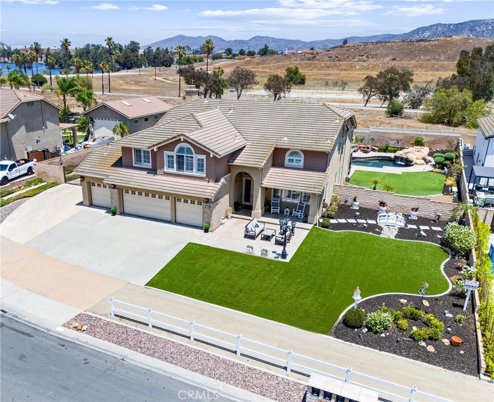 Welcome to this exceptional property in the coveted Sycamore Ranch community, where luxury meets the equestrian lifestyle on nearly half an acre of private, beautifully manicured grounds, including turf for ease of maintenance. Offering 5 spacious bedrooms, 3 full bathrooms, and 4,016 square feet of thoughtfully designed living space, this stunning residence is a true sanctuary of elegance, comfort, and California indoor-outdoor living. From the moment you enter through the formal entry, you’re greeted by soaring ceilings, abundant natural light, and refined finishes throughout. Plantation shutters, dual-paned windows, recessed lighting, and ceiling fans enhance comfort and style at every turn. The formal dining room impresses with coffered ceilings, ideal for entertaining, while the expansive extra-large bonus room offers endless possibilities for recreation or relaxation. The heart of the home is the chef’s kitchen, featuring high-end appliances, granite countertops, a walk-in pantry, and a charming dining area that overlooks the exquisite backyard oasis. The adjacent family room is anchored by a striking stacked-stone fireplace, creating a warm and inviting atmosphere. A main-floor bedroom with a private en-suite bathroom offers ideal guest or multi-generational living. Upstairs, the grand primary suite is a luxurious retreat, boasting its own fireplace, a spa-inspired en-suite bath with dual sinks, a walk-in shower, oversized soaking tub, and a generous walk-in closet. Step outside to an entertainer’s paradise. The expansive backyard is a private haven with no rear neighbors. Featuring a resort-style Pebble Tec heated pool and spa with a stunning rock waterfall, a soothing water feature, and an outdoor living room complete with a fireplace and built-in barbecue. Whether hosting gatherings or enjoying peaceful evenings under the stars, this space offers unmatched serenity & style. Ideally located near Pacer Park, enjoy access to a public riding ring, equestrian trails, and a children’s playground—adding convenience & recreation to the luxurious lifestyle. Experience the ultimate in upscale country living in one of Norco’s most sought-after communities, where elegance meets function in every detail.