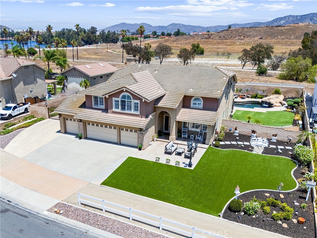 Welcome to this exceptional property in the coveted Sycamore Ranch community, where luxury meets the equestrian lifestyle on nearly half an acre of private, beautifully manicured grounds, including turf for ease of maintenance. Offering 5 spacious bedrooms, 3 full bathrooms, and 4,016 square feet of thoughtfully designed living space, this stunning residence is a true sanctuary of elegance, comfort, and California indoor-outdoor living. From the moment you enter through the formal entry, you’re greeted by soaring ceilings, abundant natural light, and refined finishes throughout. Plantation shutters, dual-paned windows, recessed lighting, and ceiling fans enhance comfort and style at every turn. The formal dining room impresses with coffered ceilings, ideal for entertaining, while the expansive extra-large bonus room offers endless possibilities for recreation or relaxation. The heart of the home is the chef’s kitchen, featuring high-end appliances, granite countertops, a walk-in pantry, and a charming dining area that overlooks the exquisite backyard oasis. The adjacent family room is anchored by a striking stacked-stone fireplace, creating a warm and inviting atmosphere. A main-floor bedroom with a private en-suite bathroom offers ideal guest or multi-generational living. Upstairs, the grand primary suite is a luxurious retreat, boasting its own fireplace, a spa-inspired en-suite bath with dual sinks, a walk-in shower, oversized soaking tub, and a generous walk-in closet. Step outside to an entertainer’s paradise. The expansive backyard is a private haven with no rear neighbors. Featuring a resort-style Pebble Tec heated pool and spa with a stunning rock waterfall, a soothing water feature, and an outdoor living room complete with a fireplace and built-in barbecue. Whether hosting gatherings or enjoying peaceful evenings under the stars, this space offers unmatched serenity & style. Ideally located near Pacer Park, enjoy access to a public riding ring, equestrian trails, and a children’s playground—adding convenience & recreation to the luxurious lifestyle. Experience the ultimate in upscale country living in one of Norco’s most sought-after communities, where elegance meets function in every detail. Just a quick 7 miles from the Orange County line off the 91 Frwy. And let's not forget: NO HOA, NO MELLO ROOS & LOW TAXES! Seller is willing to consider seller financing incentives as well as buyer concessions.