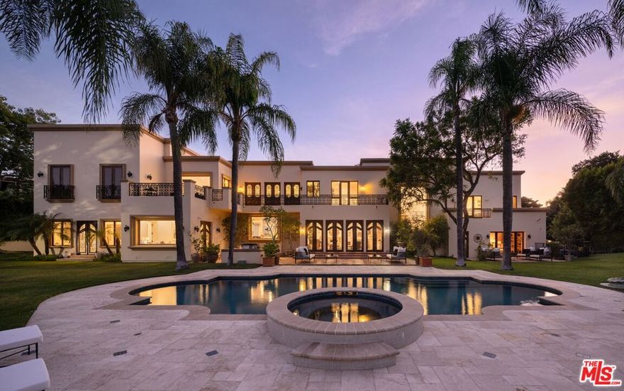 Rare double lot in the exclusive guard gated community of Mulholland Estates in Beverly Hills, 3364 Clerendon Road is one of the neighborhood's largest flat parcels. Perfectly positioned on a corner, the property boasts breathtaking views, an ideal layout, and grand scale. Crafted with exceptional quality, this gated estate offers a private ingress and egress motor court with ample parking, expansive lawns, and resort style amenities including a large pool, spa, sun deck, and built in grill, perfect for effortless outdoor entertaining. Enter through a double height foyer into a bar equipped family room, an elegant formal living room, a gourmet kitchen, formal and informal dining rooms, and a versatile game room. The main level also includes a spacious office, guest suite with en suite bath, powder room, and access to the three car garage. Upstairs features three guest suites with en suite baths, a home theater, and the primary suite. The primary suite is a world of its own, offering dual spa inspired baths, a sauna, steam shower, wet bar, and an extraordinary two level boutique style closet, an unmatched showpiece. This unique estate seamlessly blends timeless architectural detail with modern amenities for comfortable luxury living. A true generational Beverly Hills asset, offering unparalleled privacy and sophistication.