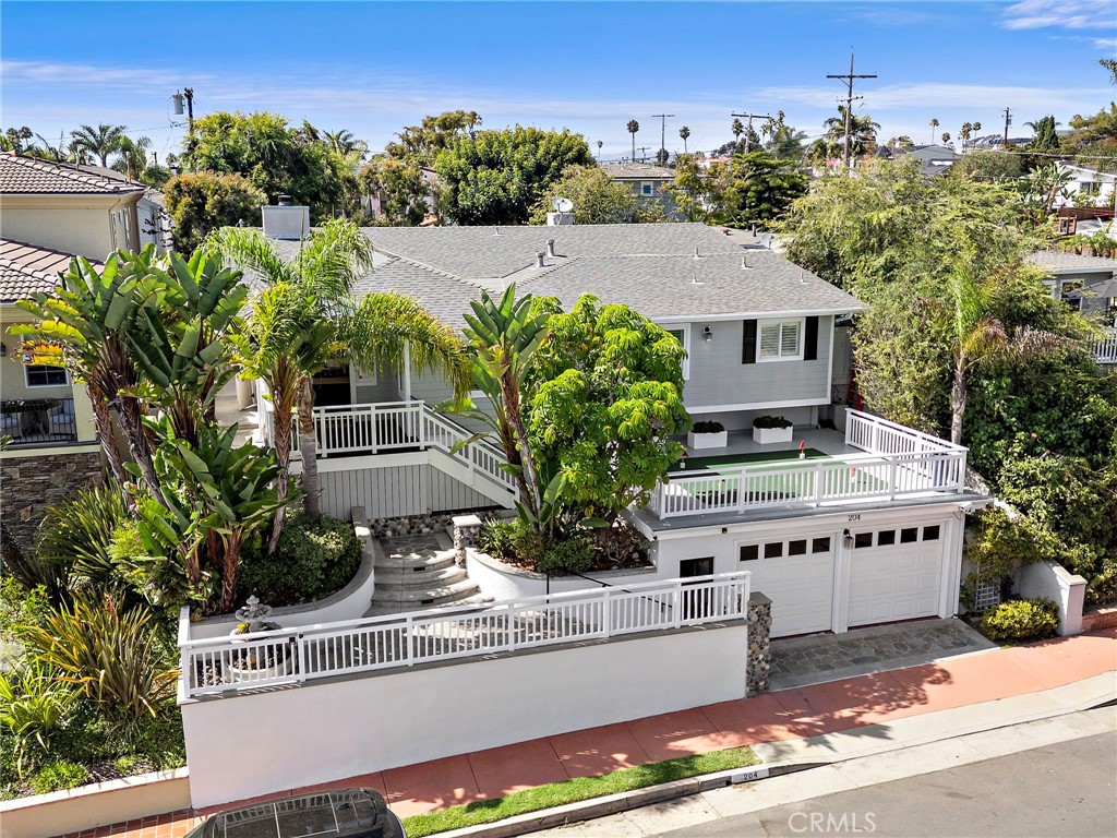 Southwest San Clemente boasts some of the most coveted streets in town, and this timeless coastal property puts you right in the heart of it. Just one block from T-Street access and less than half a mile to the sand, the location delivers the ultimate beachside lifestyle with Downtown San Clemente and the pier only minutes away. Set on a generously sized lot, this 2,546 square foot home offers four bedrooms and two-and-a-half bathrooms, with a floor plan designed for both relaxation and entertaining. A well-maintained exterior with lush landscaping, spacious front deck, and covered porch create a warm coastal welcome. Heading inside through a stunning Dutch door, the living and family rooms provide flexible spaces, while classic character shines through with beamed ceilings, wide-plank wood flooring, expansive windows, custom shutters, and cozy fireplace. The kitchen offers excellent functionality with a Wolf range, wine and beverage refrigerators, sleek concrete countertops, and breakfast bar seating. The primary suite is a private retreat with a vaulted beamed ceiling, built-in window bench, large walk-in closet, and fireplace. The ensuite bathroom features a walk-in shower, separate soaking tub, and a double vanity, creating a comfortable and functional space. Three spacious bedrooms and a full bathroom round out the interior spaces of the home. Outdoor living is where this property truly shines. Surrounded by mature privacy landscaping, the backyard offers multiple entertainment areas, a large lawn, above-ground spa, and plenty of space to enjoy San Clemente’s year-round sunshine. Additional conveniences include a fire sprinkler system, interior laundry area, built-in storage, and a versatile shed with power that has been converted into a home office. With a peek-a-boo ocean view, thoughtful upgrades, and an exceptional location, this home offers the best of Southwest San Clemente living.