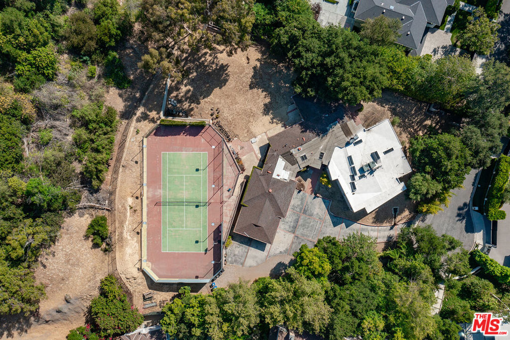 Welcome to 16145 High Valley Place a once-in-a-generation offering in the heart of Encino's coveted Royal Oaks. Set at the end of a private cul-de-sac behind gates, this nearly 1-acre parcel (42,795 sq ft) presents an unmatched canvas for visionary builders and estate seekers alike. The property allows up to ~13,299 SF addition/remodel or up to ~15,958 SF brand new construction. Current residence is 4,616 SF and a full-size tennis court, situated on a broad flat pad. Whether you're building new, expanding, or repositioning for resale, the value lies in the land, location, and entitlement potential. Comparable new estates nearby have sold in the $15M-$18M range. Whether you're a seasoned developer or end-user looking to create generational wealth and lifestyle, this is the lot that rarely hits the market.