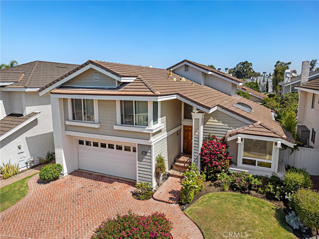 Rare four-bedroom lake view home by South Lake in Woodbridge's "Landing I" community. Original owner is downsizing from this upgraded Plan 4 situated in a pristine Cul de Sac, just one house away from the lake. With small views of the water from the spacious living room and two bedrooms, the lake walkways are just a 20 second stroll from the front door. Creatively remodeled, the new floor plan incudes an open gourmet kitchen and redesigned living room under sunlit vaulted ceilings. The "Provence" inspired kitchen provides an abundance of custom cabinetry, stainless appliances, stone surfaces, double sink, work station, pantry and all surrounds a large center island with stools. The formal dining area seamlessly involves the kitchen and flows through french doors to the rear yard.The classic step-down family room boasts an elegant fireplace, kitchen connection and glass doors bringing in garden views. A laundry room, guest bath and direct access to the two car garage rounds out the main level. Upstairs, two of the four bedrooms again provide views of South Lake. The primary suite is large and accented with high ceilings and multiple windows. The suite's bath includes a massive walk-in closet, separated stone sink counters, generous oval tub and a separate shower. The professionally maintained rear gardens are accented with brick, tile, stone, fruit trees (lemon, grapefruit, lime & orange), flowering shrubs, classic French Bleu tile and two distinct gathering areas. In addition to the lake-close positioning of this home, nearby are all the popular amenities of the Woodbridge community. This particular home is rarely on the market and may well be your "Landing".