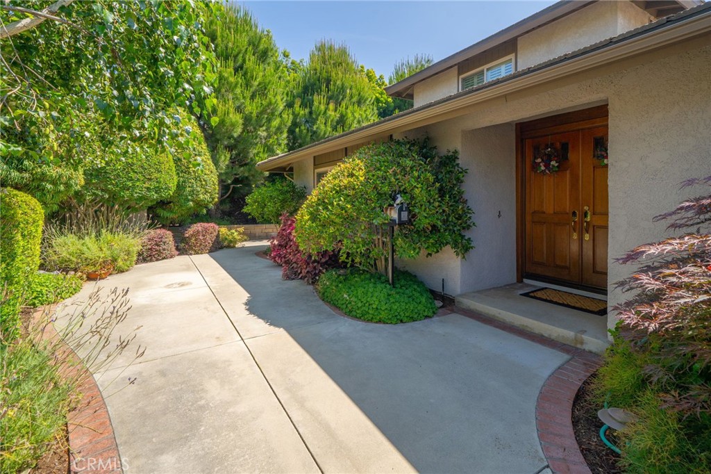 Located in one of North Glendora’s most desirable neighborhoods, this six bedroom three bathroom pool home is within walking distance to award-winning Glendora schools, hiking trails, and parks. Enter this beautiful home through double doors off the private courtyard. The large open living room has views to the courtyard, plantation shutters, and offers a perfect place for entertaining or relaxing with a book. The formal dining room has a sliding door with plantation shutters out to a large side patio that is ideal for private outdoor dining or summer entertaining. Adjacent to the dining room is the kitchen with custom oak cabinetry and Corian counters, breakfast area with sliding door to backyard, built-in desk space, and views to the backyard and the foothills. The breakfast area opens to an inviting family room with floor-to-ceiling brick fireplace, skylights for ample natural light, and vaulted, wood beamed, ceilings. Down the hallway is a full bathroom with dual sink vanity with quartz counters and custom oak cabinetry. The first of four bedrooms makes for a perfect office or study while another offers two closets and plenty of extra space. The third bedroom has a door into the master suite and makes for a perfect nursery. All three bedrooms have plantation shutters. The spacious master suite has a sliding door with shutters to the back patio and an ensuite ¾ bathroom with two closets. At the end of the hallway you’ll find a laundry room adjacent to the three car attached garage with a water softener and workbench. Upstairs you will find two very spacious bedrooms and a ¾ bathroom with their own HVAC system offering a retreat for guests, older children, or those seeking privacy. This wonderful home sits on a 12,170 sqft lot with a newly replastered pool and spa, lush grass and landscaping, and plenty of privacy. Upgrades include dual pane windows and sliding doors, a whole house fan, water softener, two HVAC systems, upgraded oak cabinetry, plantation shutters, and fire resistant concrete tile roof. This home is a true gem.