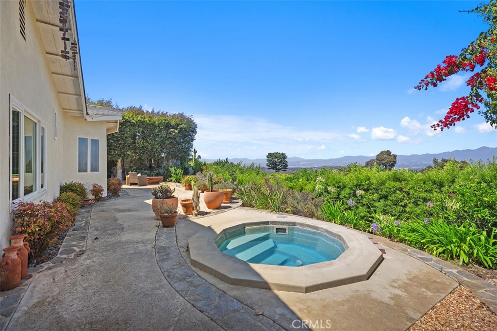 Single-Level PANORAMIC VIEW home perched up at the end of a quiet cul-de-sac in Laguna Beach's desirable Top of the World neighborhood. This well maintained single-level home offers sweeping panoramic views of Saddleback Valley, surrounding mountains, and twinkling city lights at night. With 4 bedrooms & 3 bathrooms, the layout is both functional and flexible. The expansive primary suite features mountain views, generous closet space, an ensuite bathroom with dual-sink vanity and walk-in shower, plus double doors that open directly to a private outdoor spa. Two secondary bedrooms share a full hallway bath with tub/shower combo, while the fourth bedroom—with its own private bath and walk-in shower—is perfect for guests, in-laws, or a home office. An elegant and spacious formal dining room comfortably accommodates large gatherings and enjoys stunning views—making it an ideal space for entertaining. Inside, the home exudes charm with Spanish-style touches, including arched doorways, an ornate front door, and decorative double doors leading to the backyard. The spacious family room offers vaulted wood plank ceilings, a cozy fireplace, and dramatic vistas. The kitchen is a chef’s dream, equipped with high-end appliances: full-size Sub-Zero built-in refrigerator and freezer, professional-grade Viking 6-burner gas range with griddle, double ovens, warming shelf, pot filler, apron sink, walk-in pantry, under-cabinet lighting, and stainless-steel finishes throughout. Enjoy a very private backyard with multiple seating areas and a private spa—perfect for relaxing under the stars. The home also features fully owned new solar panels, a two-car garage with built-in cabinetry, recessed lighting, laundry area, and an extra side driveway ideal for golf cart parking. Additional interior features include a convenient pull-down ladder leading to attic storage. A unique advantage in Laguna Beach: all three highly rated public schools—elementary, middle, and high—are located nearby. Top of the World is beloved for its incredible views of Catalina Island, Mt. Baldy, and the Pacific Coastline. Nature lovers will enjoy direct access to miles of scenic trails at nearby trailheads & Alta Laguna Park, which also features tennis courts, a playground, basketball court, and more. Just minutes away, downtown Laguna Beach offers world-class beaches, art galleries, festivals like Pageant of the Masters, boutique shopping, and a variety of acclaimed dining options.