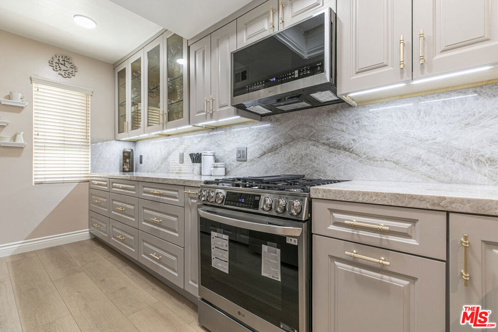 Welcome to this beautifully updated 2-bedroom, 2.5-bathroom townhouse offering 1,204 square feet of modern living space in a prime location. Enjoy a fully renovated kitchen featuring brand-new cabinetry, state-of-the-art LG appliances, and luxurious Taj Mahal Quartzite countertops perfect for cooking and entertaining. The home boasts new laminate oak plank flooring throughout, recessed lighting, fresh paint, upgraded baseboards, and dual pane windows that provide energy efficiency and natural light in every room. The spacious primary bedroom includes a private en-suite bathroom and walk-in closet, the second bedroom is generously sized with an adjacent hall bathroom. An in-unit washer and dryer add everyday convenience. Community amenities include a secured parking garage with ample guest parking, on-site storage, a sparkling pool, and a clubhouse for gatherings or relaxing weekends. With easy access to freeways, public transportation, dining, and shopping, this move-in ready townhouse offers the perfect combination of comfort, convenience, and style. Don't miss out on this exceptional opportunity!