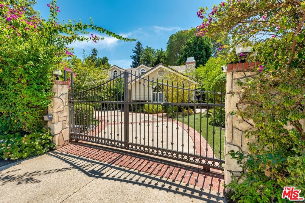 FIrst time on the market in 30 years! This iconic Rancho Estates compound is ensconced behind mature landscaping and a dual gated circular drive. The inviting front veranda leads to a formal 2 story entry flanked by a living room with fireplace and vaulted ceiling as well as a banquet sized formal dining room. A seamless flow across natural toned oak hardwood floors reveals a central great room with soaring ceilings, additional fireplace & wet bar opening to a true gourmet's center island kitchen with breakfast area & coffee/breakfast bar. French doors open to a magical entertainer's retreat offering a cathedral ceiling covered living/dining area, lagoon pool/spa and tiered grassy areas shaded by specimen trees and plantings. A professional greenhouse, sport court, Zen meditation platform & Pool House/Guest Quarters building with bedroom & bath, complete this resort style setting. The ideal floor plan includes an expansive primary suite with fireplace, spa style bath and walk in closets offering direct poolside access. 2 additional generously sized suites are adjacent to the primary. A guest/maids bed and bath are off the kitchen as well as direct access garage. An additional upstairs guest suite with bath, kids fun zone play area, another bedroom turned into a closet, and a home office complete the second level. Surrounded by Multi Million dollar estates, this home offers move in ready condition combined with limitless potential for its next lucky owner.