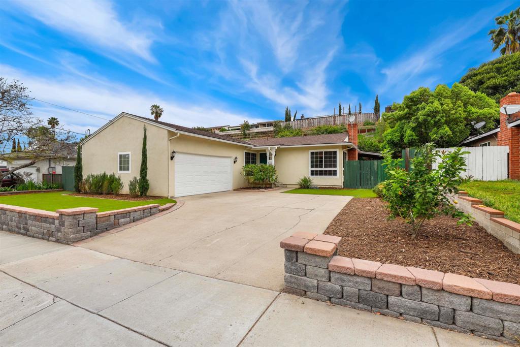 Not Your Typical La Mesa Home—This One Shines! Break free from the ordinary with this standout single-story 3-bedroom, 2-bath home in the heart of La Mesa. Bursting with custom touches and thoughtful updates, this residence offers a refined take on suburban living. The kitchen features ample cabinet and counter space with a custom built-in wine bottle display, and the renovated primary bathroom brings a modern edge, while every room has been curated for comfort and style. Enter into a welcoming formal living room with a charming fireplace, rich original hardwood flooring, and a custom shiplap accent wall that adds warmth and character. You'll love having two distinct living spaces—the separate family room steals the show with crisp white paint, stunning open-beam ceilings, shiplap details, and a dramatic wall of windows and dual sliding glass doors to access both a covered outdoor patio, and charming backyard, bringing in loads of natural light and blurring the lines between indoor/outdoor living. Whether you're hosting or just relaxing, the covered patio and spacious backyard make the perfect extension of your living area. Up front, low-maintenance landscaping with lush artificial turf gives you a polished look without the upkeep. Practical perks include a two-car garage, no HOA fees, and no Mello Roos—offering you both convenience and freedom. Ideally located less than 1/4 mile from the nearest Trolley station (Amaya Drive, offering a connection to both the Green and Orange lines), as well as less than 30 minutes from Downtown San Diego, Mission Bay, Balboa Park, and more, this home delivers the best of both worlds: proximity to it all, with room to unwind. Stylish, functional, and unforgettable—this home is ready to impress.