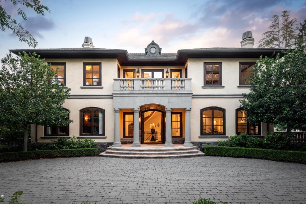 In the heart of Lindenwood, this home evokes romantic elegance with its grand foyer and incredible craftsmanship evident at every turn. The main floor provides a dedicated paneled office with fireplace, formal living room with fireplace and dining room with coved ceiling and tray lighting. The gourmet kitchen features a barrel-vaulted ceiling, top-of-the appliances -Sub-Zero and two dishwashers and fully open to the family room with 12' ceiling, central fireplace and multiple French doors leading to the grounds. Main level primary suite is a sanctuary of luxury with fireplace, huge closet with washer/dryer, large bath with heated floor, steam shower. Upstairs, are four bedrooms, each with a balcony, two with ensuite baths, and two with shared bath. Two additional lower-level bedrooms, one is currently customized as a fitness center, provide versatile living options, each with direct access to a shared bath. Rounding out the lower level is a dedicated home theatre, customized wine cellar, as well as an additional full bath. Park-like grounds with three gated entrances, sparkling pool, and spa with guest house and immense privacy and. 3-car garage. Prime location, excellent Menlo Park Schools, close top rated private schools,shopping, restaurants, and commute routes.