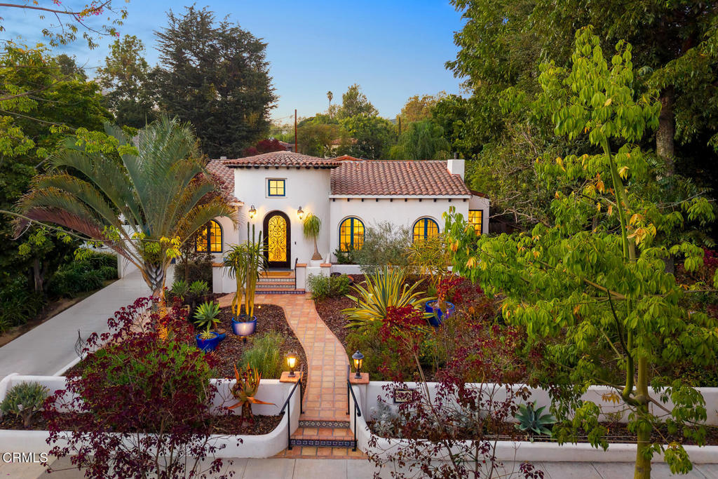 Stunning Renovated Spanish-Style Retreat with Luxe Features & Detached ADU. Welcome to this beautifully remodeled Spanish-style residence that perfectly blends timeless architectural charm with modern luxury. Situated in a serene and sought-after neighborhood, this captivating 4-bedroom, 2-bathroom home boasts refined details and exceptional craftsmanship throughout. Step through the formal arched entryway into a grand interior highlighted by soaring ceilings, rich hardwood floors, and elegant arched passageways that guide you through the thoughtfully designed living spaces. The inviting living room features a cozy fireplace, custom built-in bookshelf and dual arched windows, perfect for intimate gatherings or quiet evenings at home. The gourmet kitchen is a chef's dream, showcasing stainless steel built-in appliances, a generous center island with a second sink, two dishwashers, an abundance of counter space and open to the family room ideal for effortless entertaining and everyday living. Retreat to the spacious bedrooms for rest and relaxation, while the spa-inspired bathrooms offer a touch of luxury with upscale finishes. Step outside to your private oasis--a pergola-covered Spanish tile patio leads to a breathtaking pool and spa adorned with elegant water features. Whether lounging by the water or dining al fresco, the outdoor space is designed for year-round enjoyment. Adding even more value and versatility, the detached ADU spanning over 1,000 square feet, offers a covered patio and is ideal as a guest suite, home office or gym. This exceptional home effortlessly combines classic Spanish elegance with modern convenience--truly a rare gem not to be missed.