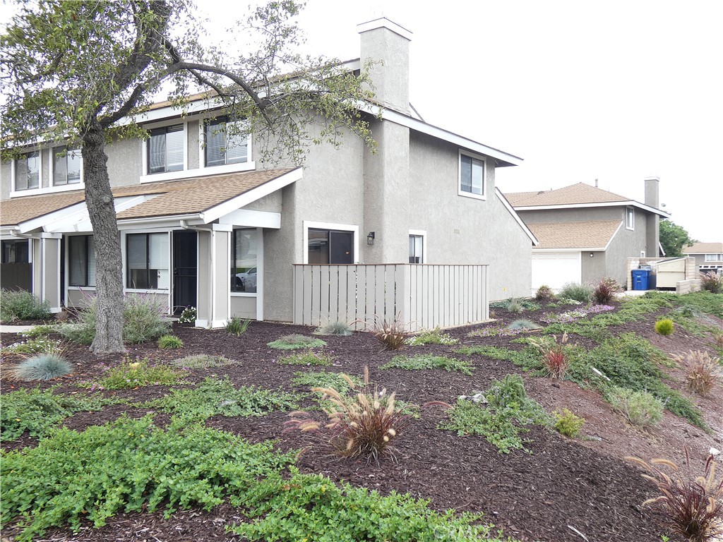 This end unit is the best and the brightest, with the extra light that this location provides, plus a sliding glass door to the fenced tiled patio, and access to the open space. In addition, the 3-bedroom plan has been upgraded with an added shower in the first-floor bath, providing more value and benefit to this polished home. Features include a sunlit dining area that opens to the great room, with a focal point fireplace, and patio access, expanding your living and entertainment area. The spacious master suite includes a deep walk-in closet, and all 3 bedrooms feature cooling ceiling fans. The interior is freshly painted, and there are new screens throughout. The attached oversized and finished garage provides additional room for hobbies and a workbench. This move-in-ready home is ideally located near top-rated schools, stores, and freeway access. The complex is well-maintained and includes a clubhouse, pool, trash, water, and sewer service, as well as the structure exterior maintenance. This is not just a home; it is a lifestyle!