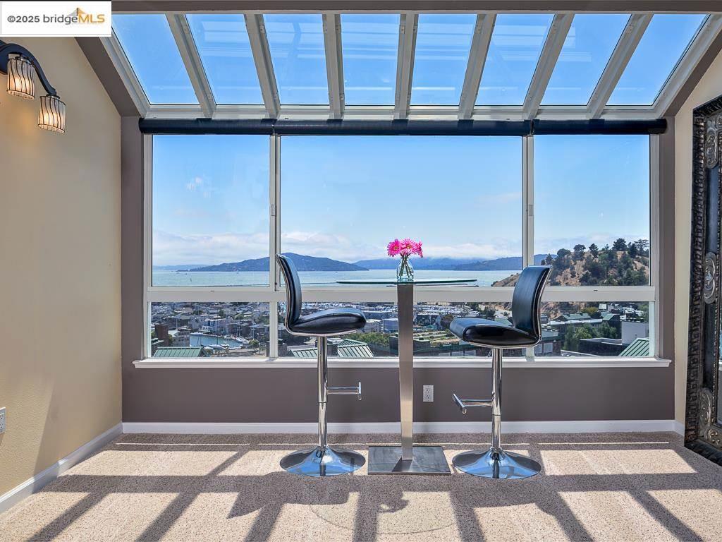 Located on the third floor of the tallest building at Brickyard Landing, this two-bedroom, two-bath condo offers spectacular views of San Francisco, the Bay, and Angel Island. Relax in the solarium as you watch sailboats glide by during the day and the city lights sparkle at night. The modern kitchen features granite countertops and wood cabinetry, opening seamlessly into a bright living-room/dining area anchored by a gas fireplace. The spacious primary bedroom boasts ample closets and an en-suite bathroom with a stall shower and a deep soaking tub. The second bedroom includes a custom built-in Murphy bed and desk, both included in the sale. Solarium and main bedroom windows have been upgraded with premium double-pane glass and new frames. Pinnacle’s expansive backyard—bordering Miller Knox Regional Park—is perfect for picnics or relaxing on the lawn. The unit comes with two parking spaces and 3 additional storage lockers. HOA amenities feature a year-round heated pool, fully equipped gym, saunas, spa, tennis and pickleball courts, a clubhouse, community garden, and EV charging stations. Commuters will appreciate easy access to Berkeley, Oakland, and Marin via I-580, as well as nearby ferry service from Richmond to San Francisco, Amtrak, and BART.