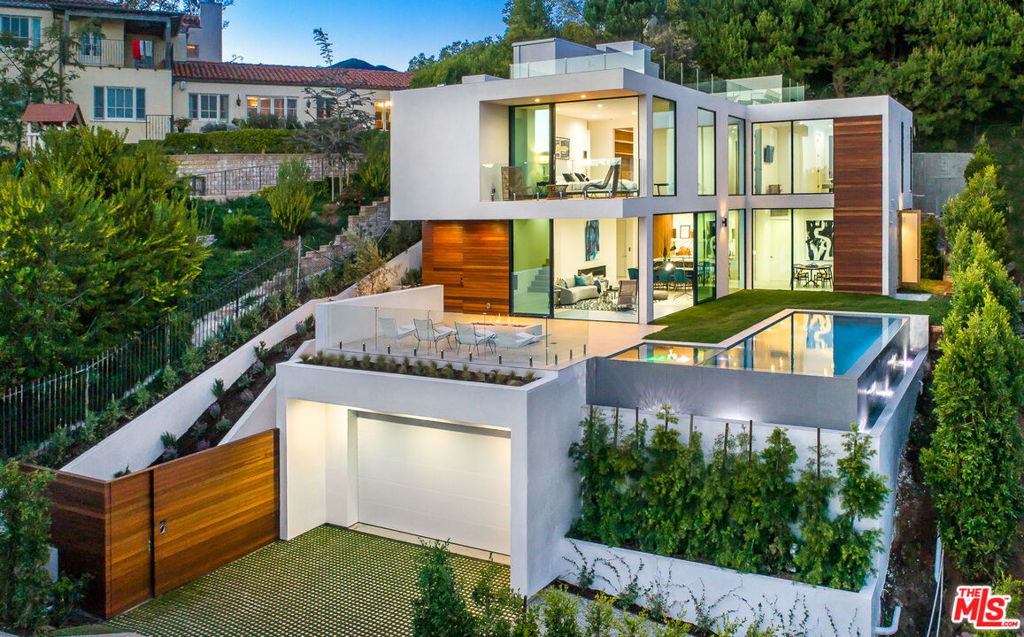 No need to build, this home is ready now! Built in 2018, this exceptional contemporary home in the prestigious Pacific Palisades offers breathtaking Pacific Ocean and panoramic city views. Located on a quiet street overlooking the Palisades Village, this architectural masterpiece spans three levels, featuring 5 bedrooms, 6.5 baths, and seamless indoor-outdoor living. The main level boasts an open floor plan with a sleek European kitchen, dining area, and a spacious family room with expansive sliding glass doors that open to a stunning infinity pool with an integrated spa. Upstairs, the luxurious primary suite impresses with an expansive walk-in closet and spa-like bath, accompanied by two generous guest suites. The lower level offers a large media/game room, laundry room, and an additional bedroom"perfect for guests or a private retreat. An elevator provides easy access to all levels, including the sprawling rooftop deck, where you can soak in unparalleled sunset views. Experience the ultimate in coastal luxury with this extraordinary home, just moments from the best of Pacific Palisades. Property can be sold fully furnished.