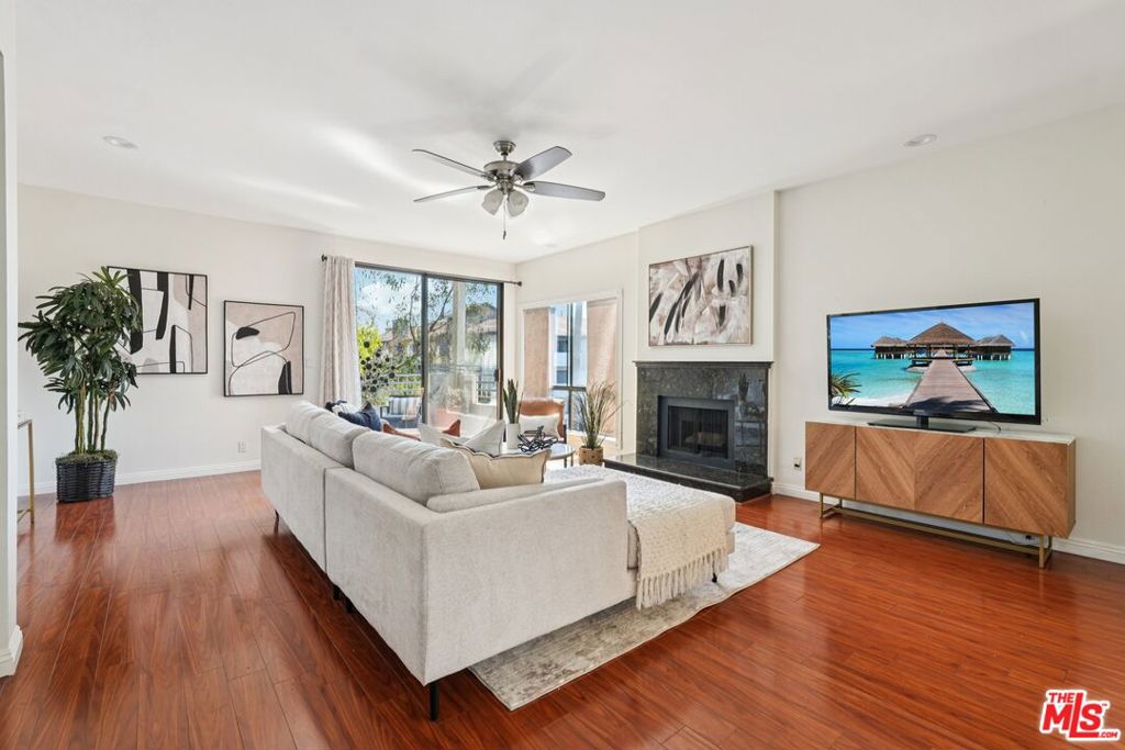 Nestled between Santa Monica and Brentwood, this West LA condo is among the largest 2-bed, 2-bath units currently for sale -- OFFERED AT THE LOWEST PRICE PER SQUARE FOOT ON THE MARKET. Exit the private elevator into a grand double-door entry framed by marble tile flooring, leading into a spacious, single-level interior filled with natural light. The open living room offers hardwood floors, a modern granite gas fireplace, and access to a large tiled balcony with a private storage closet. The formal dining area is perfect for entertaining, featuring a striking light fixture and a built-in wet bar. The updated kitchen is outfitted with granite countertops, a tray ceiling with recessed lighting, ample cabinetry, and stainless steel appliances. Both bedrooms are generously sized and naturally bright. The primary suite includes a fully renovated bathroom with double vanities, travertine tile, a walk-in shower, and a brand-new freestanding soaking tub. Additional features include just one shared wall, an in-unit stackable washer, upgraded HVAC, electrical, and plumbing systems, two secured tandem parking spots with storage, and controlled access to both the building and elevator. Ideally situated near popular local hotspots with top-tier walkability and seamless access to the 405 and 10 freeways, this location offers the perfect balance of lifestyle and convenience.