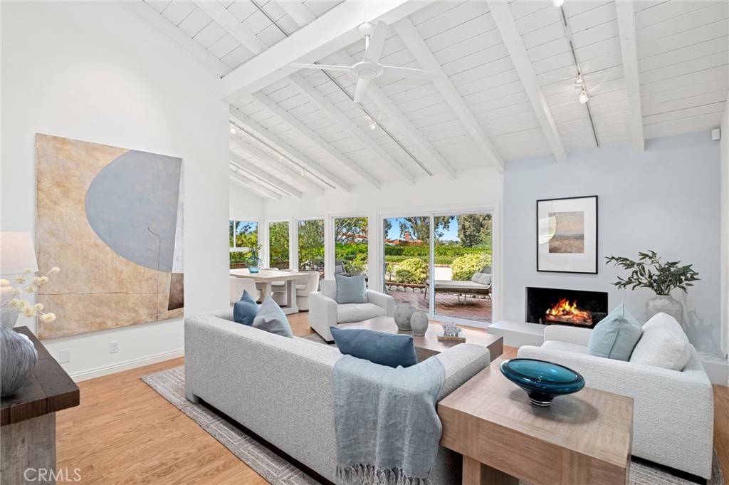 SINGLE-STORY expanded END UNIT in highly desirable Bluffs in Newport Beach! Rarely available 2,000 sq.ft. (approx.) home offering 3 bedrooms, 2 baths, PLUS a large private office, all bathed in natural light. The expanded foyer is the perfect spot to greet your guests or retreat to the private office with large skylight. Panoramic views stretch across the kitchen, dining room, living room and backyard, creating a serene backdrop for everyday living. The home is appointed with hardwood floors, fireplace, central air conditioning, track and recessed lighting and dual pane windows throughout. The primary suite impresses with vaulted ceiling, large walk-in shower, separate tub, dual sinks and complete with custom built-ins. The spacious and private wrap-around patio is ideal for al fresco dining and entertaining or just taking in the beautiful surroundings. An additional feature includes a finished garage with custom built-ins for storage and work area. Residents can enjoy access to the nearby community pools, the convenience of close proximity to Fashion Island, fine dining, scenic hiking and biking trails, beaches, and top-rated schools.
