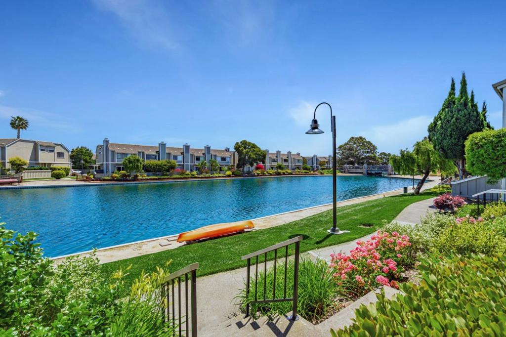 Homes like this are a RARE find, this is YOUR chance to own this WATERFRONT GEM! Step into this bright and airy home featuring two large sized bedrooms upstairs, elegantly updated bathrooms, and a spacious two-car garage. The front deck offers breathtaking water views, and the private backyard is great for relaxation. The contemporary kitchen is equipped with brand new dishwasher, premium stainless steel appliances, and ample counter space, PERFECT for hosting and entertaining guests. Both bathrooms have been upgraded with stylish vanities and fixtures, and a sliding barn door adds a modern touch to the primary ensuite bathroom. Enjoy resort-style community amenities including a swimming pool, hot tub, tennis court, playground, and clubhouse. THIS IS IT, do not let this one slip away! HOA covers water and garbage.