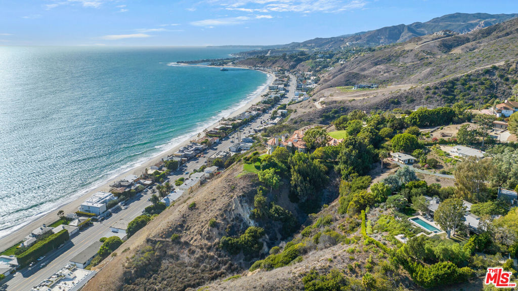 Perched atop a two-acre promontory with unobstructed views, this incomparable legacy property is the pinnacle of modern living within one of the world's most coveted coastal settings. This turnkey 4 Bed 3.5 Bath retreat spans 4,000 Sq Ft across a single level, anchored by a majestic great room with exposed vaulted ceilings and Fleetwood sliders opening to an infinity edge pool and breathtaking ocean views. Gourmet kitchen with center island, full bar, and seating area with fireplace. Primary suite comes with grand scale spa-like bath, custom built-ins, walk-in closet and third fireplace. Two additional guest bedrooms, two car garage, and secondary gated entrance for guests or services. Indoor/Outdoor living throughout with nearly each room providing direct access to the outdoors, allowing the curated grounds to become an integral part of the living experience. Property comes with membership rights to coveted La Costa Beach and Tennis Club. Incredibly accessible location in Eastern Malibu close enough to commute to town, and in close proximity to local hotspots Nobu, Little Beach House, Malibu Country Mart and the highly anticipated Cross Creek Development.
