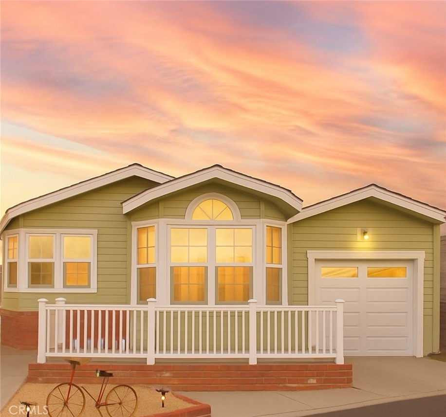 Welcome to Huntington Harbour Village a condominium community of manufactured homes for ages 55+ where residents own their land with no space rent! Just minutes from the beach. This well-maintained, move-in-ready home offers 2 bedrooms, 2 bathrooms, a dedicated office, and an open-concept layout filled with natural light. Vaulted ceilings and skylights create an airy feel, while ocean breezes, ceiling fans, and central A/C keep you comfortable year-round. Enjoy luxury vinyl plank flooring throughout, a modern kitchen with solid-surface counters, gas range, microwave, dishwasher, and a pantry with pull-out drawers. The office features a built-in desk and wall unit- perfect for remote work or hobbies. The spacious primary suite includes dual sinks, closet organizers, and a charming window seat. The laundry room gives you plenty of extra storage, and outside, a charming white picket-fenced patio is perfect for relaxing or entertaining. The garagette with its matching built-in shed ties the home all together with style. Huntington Harbour Village offers resort-style amenities: remodeled clubhouse with catering kitchen, heated pool, spa, saunas, fitness room, game/card lounge, putting green, BBQ area, and RV storage rentals. All this, just minutes to beaches, shopping, Bolsa Chica trails, and paddle boarding.