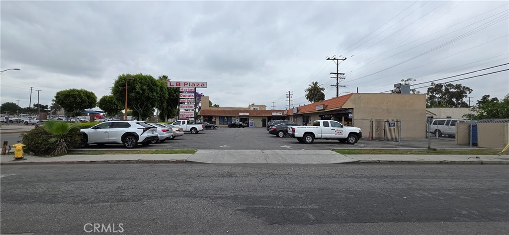 This building is an L-shaped structure with five stores. Currently, three of the stores are in operation, and the other two are vacant. There is a one-room studio on the rooftop and ample parking available.