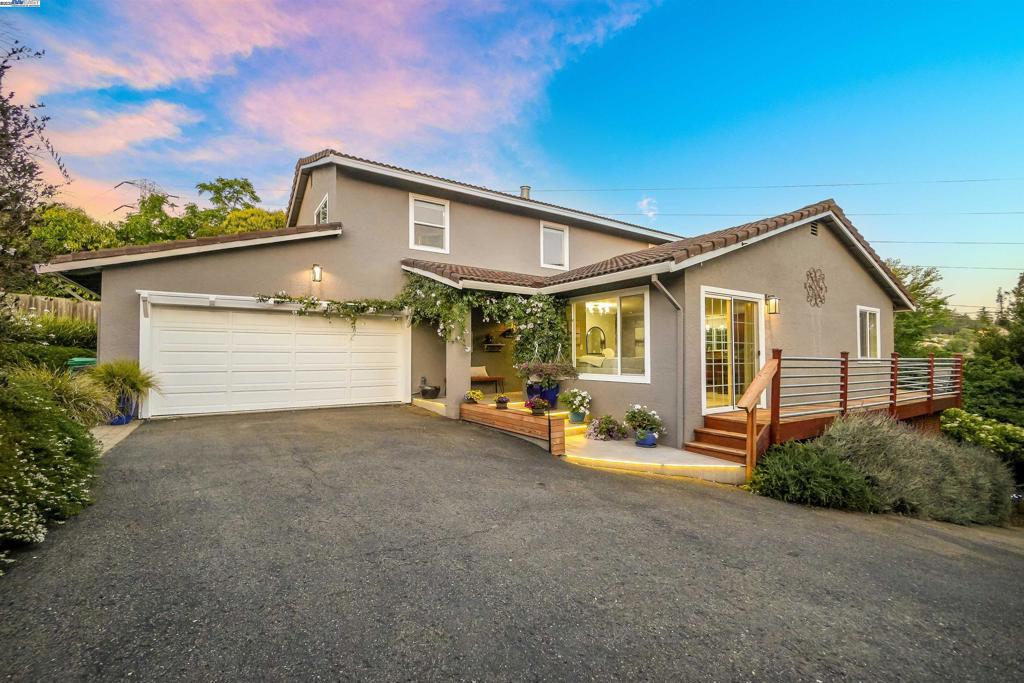 Tucked away on a private road in the serene Hayward Hills, this spacious home offers privacy, charm, and stunning hillside views. Step inside to find crown molding, recessed lighting, and an abundance of natural light throughout. The welcoming family room flows into a generously sized kitchen featuring ample cabinet and counter space, high end stainless steel appliances, and breathtaking views of the hills. Adjacent to the kitchen is a cozy living room with a fireplace. There are three separate sliding glass doors that open to the expansive deck, perfect for indoor-outdoor living! A bedroom and a fully remodeled bathroom are located on the main level, along with a convenient bar area, large under-stair storage, laundry room, and direct access to the spacious two car garage. Upstairs, you'll find two roomy guest bedrooms, a full bathroom, and a large primary suite complete with a walk-in closet, en suite bathroom, and a private deck with more gorgeous hillside views. The extended driveway accommodates multiple vehicles, and the lushly landscaped exterior is adorned with vibrant flowers and mature greenery, creating a peaceful retreat you’ll love coming home to. With only one next door neighbor, you have total privacy! Come make this home your own private oasis.