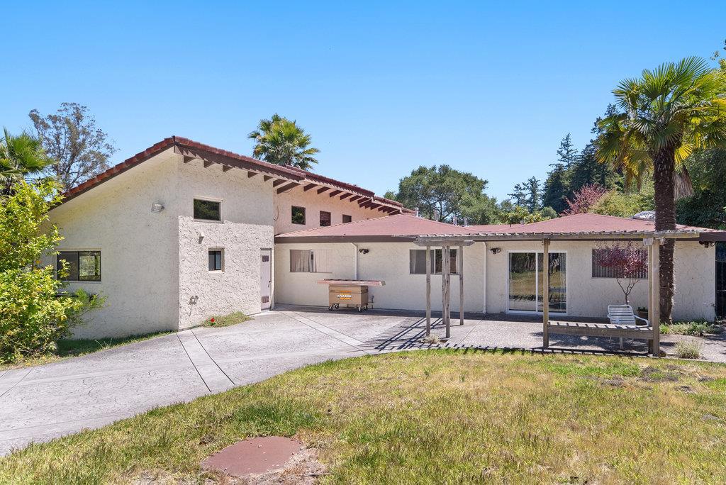 Sprawling 3,206 sq.ft., one story home on 2.5 acres, bordering the Santa Cruz and Scotts Valley areas. Great commuter location to UCSC and the San Jose area. Four bedrooms and a bonus room currently used as a 5th bedroom. Four full baths, Large living room, currently divided as a living area with wet bar and fireplace, also a sitting area by the main entrance, off the kitchen. There is a great room with fireplace open to the dining area and kitchen, a great gathering area. A patio area off of the dining area offers opportunity for outdoor gatherings. Large primary bedroom has sliding glass door leading to an outdoor sitting area. Huge laundry room adjacent to a pantry. Circular driveway, with carport parking for 4-6 cars and storage cabinets, and separate garage. Uncovered parking on the property for many more cars. Great large home that accommodates many people, or an investment property for renters, UCSC students.