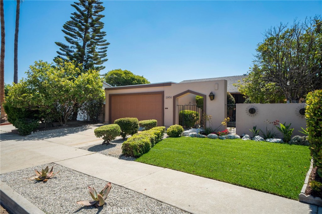 Green Meadows – Beautifully Updated Single-Story Home | 4 Beds | 2 Baths | 1,575 Sq Ft: Welcome to this spacious single-story home in the desirable Green Meadows neighborhood. Thoughtfully upgraded, this 4-bedroom, 2-bath home features a kitchen remodel completed in 2021 with new shaker cabinetry, high grade laminate countertops, a movable center island, new appliances, and a walk-in pantry. Enjoy the brand-new front landscaping, including lush grass, a welcoming walkway, and drought-tolerant plants. The private front porch offers a charming place to enjoy your morning coffee. The open floor plan connects the kitchen to the spacious living room with soaring ceilings, smooth-finished ceilings, and a formal dining area. A separate family room with a cozy fireplace provides additional space to gather and relax. The primary bedroom includes an en-suite bath, while the secondary bedrooms offer wood flooring and mirrored closet doors. The redesigned hall bath showcases dual sinks, a modern vanity with quartz counters, stylish fixtures, and a linen closet for extra storage. The generous backyard is a blank canvas, ready for your personal touch – garden, play space, or outdoor retreat.