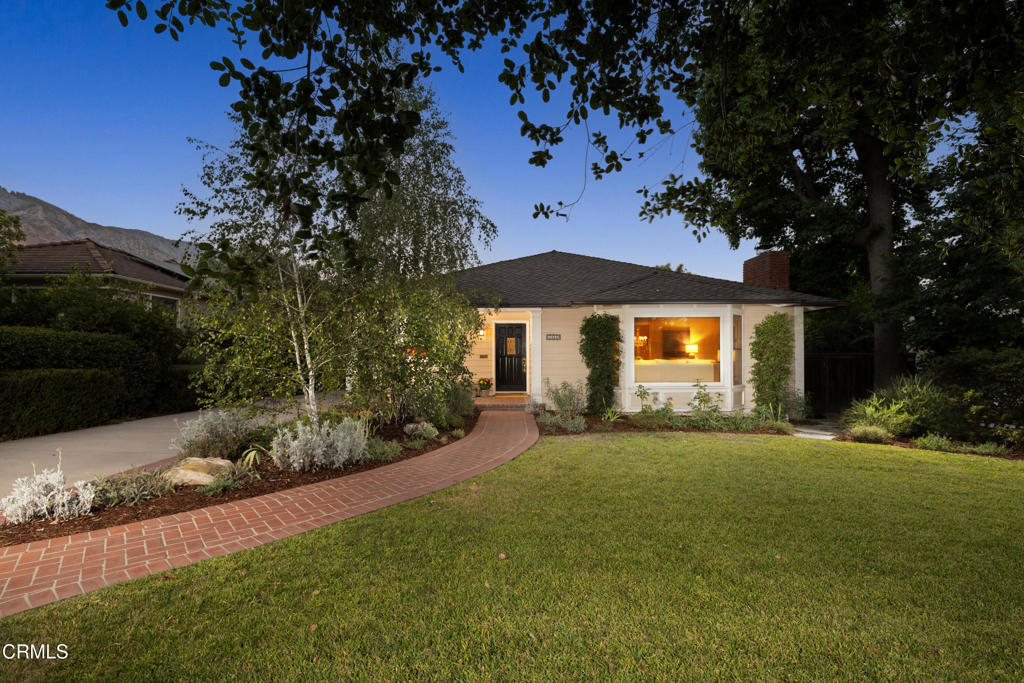 Located in the President Streets of Altadena, this idyllic traditional has been well-loved for decades by the present owners and beautifully expanded and remodeled with luxurious finishes and modern amenities. The open floor plan is designed for entertaining with generously proportioned public rooms. The living room has a sunny bay window that overlooks the front yard, a stately fireplace with harlequin mosaic tile surround, and opens to a large formal dining room that features a vintage chandelier and sliding French doors to the side courtyard. There are rich hardwood floors throughout the public spaces that unify the design, and an airy gallery hallway connects all of the spaces. An updated kitchen with practical center island is sophisticated with dark granite counters, hand-finished cabinets, and high-end appliances including a built-in wine fridge and warming drawer. Within the kitchen there is a sunny breakfast nook with built-in banquet seating and a practical workstation for managing a busy house. A light and bright family room is separated from the kitchen by a peninsula counter ideal for pulling a stool up and keeping the chef company. The perfect place to curl up and watch a movie and with direct access through sliding French doors to the back deck, the family room embodies quintessential California living with a lovely, airy indoor/outdoor flow. There are 3 bedrooms, 2 bathrooms, and a laundry room that encompass the private space on the southeast side of the home. The very spacious primary suite includes large sleeping quarters with a bay window that features beautiful views of the back gardens, a spa-like bathroom with dual vanity and a bubble soaking tub, and a large walk-in closet outfitted with a custom closet system. The primary bedroom is also enhanced by a seamless indoor/outdoor flow though French doors. The expansive lot is well-manicured with mature gardens, verdant lawns, and a sparkling pool and spa. This gorgeous home has been thoughtfully updated and beautifully maintained by the present owners and is a really special treat!