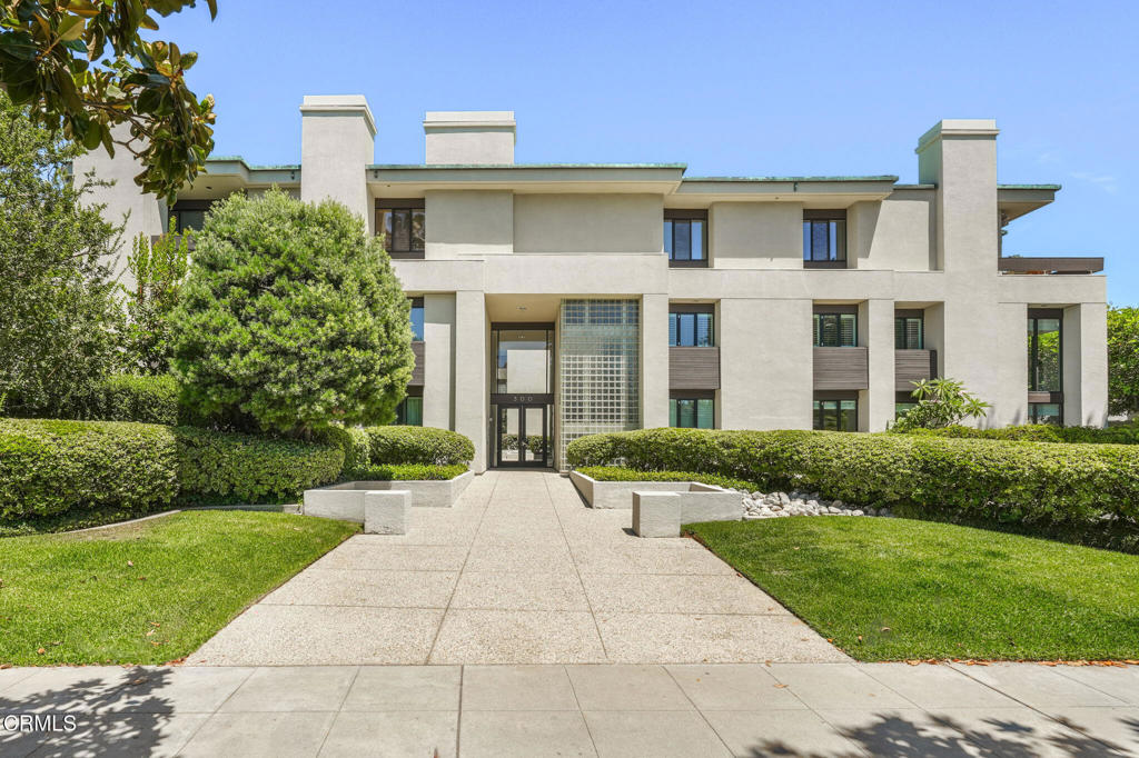 Welcome to your architectural sanctuary on Millionaire's Row. One of just eight homes that comprise the exclusive, Buff & Hensman-inspired Del Grove building, this exquisite condominium pairs brilliant natural light with a crisp, contemporary aesthetic. Secure entry from Orange Grove opens to a tranquil courtyard garden, welcoming you home with a soothing sense of calm. Inside, soaring two-story ceilings and walls of windows elevate both daily living and entertaining in the expansive living room. Slide open the glass doors and invite a cool evening breeze from the lush wraparound patio. You'll savor this incredible amenity, offering two sides of private outdoor spaces for dining, gardening, or simply lounging. Beautifully updated with style and grace, the home's sizable kitchen pairs top-tier appliances with ample cabinetry and peaceful views of the patio through the adjoining dining area. Upstairs, the expansive primary suite offers space to unwind with a good book in the front of the fireplace, squeeze in a Peloton class, or set up the perfect home office. The luxurious ensuite bath features dual vanities and an impressive walk-in closet with custom cabinetry. Two additional bedrooms--one on each floor--are bright and comfortable, with an ensuite upstairs for added convenience. In the secure subterranean garage, find three dedicated parking spaces and private storage for added convenience. With a community pool and spa, prime positioning near Old Town, and unbeatable Rose Parade access, this architectural gem celebrates beauty and invites connection.
