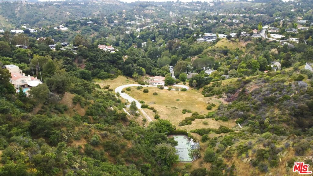 This secluded, 11 acre parcel with approximately 5 buildable acres and a championship tennis court, is ripe with possibility. Nestled in the base of a verdant valley in Beverly Crest this parcel is located at the end of a private, gated road, shared by only 3 other parcels. It is equipped with power, gas, water, and sewer connections. This extraordinary collection comprises four unique, separate, and buildable parcels, totaling 18 acres and are being sold separately or together. The parcels include: 4384-006-033, 4384-006-034, and 4384-006-035. Past architectural plans for four individual homes or one grand estate are available.