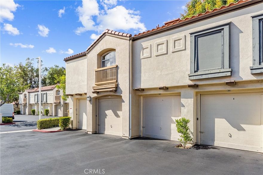 Welcome to this beautiful two-bedroom, two-bathroom carriage unit condo, with no one above or below, located in the highly sought-after Canyon Hills community in East Orange. This bright and inviting home features an open-concept layout designed for both everyday comfort and entertaining. The spacious living room offers recessed lighting, wood-style flooring, and a seamless flow into the dining area, highlighted by a contemporary chandelier and large arched window that fills the space with natural light. The kitchen is a true standout with white shaker cabinetry, sleek granite countertops, stainless steel appliances, subway tile backsplash. Both bedrooms are generously sized, with the primary suite offering an en-suite bath and walk in closet. The second bedroom provides flexibility for guests, a home office, both bathrooms feature tasteful modern finishes. Additional highlights include in-unit laundry, EV charging ready outlet in the garage, central air and heat. A private balcony provides the perfect spot to relax outdoors. Canyon Hills residents enjoy resort-style amenities, including two sparkling pools, spas, a clubhouse, a fitness center, and some utilities  covered by the HOA. This is all set against the backdrop of Santiago Oaks Regional Park with its hiking and biking trails. Conveniently located near shopping, dining, and easy freeway access, this move-in-ready home offers the ideal balance of tranquility and accessibility.
