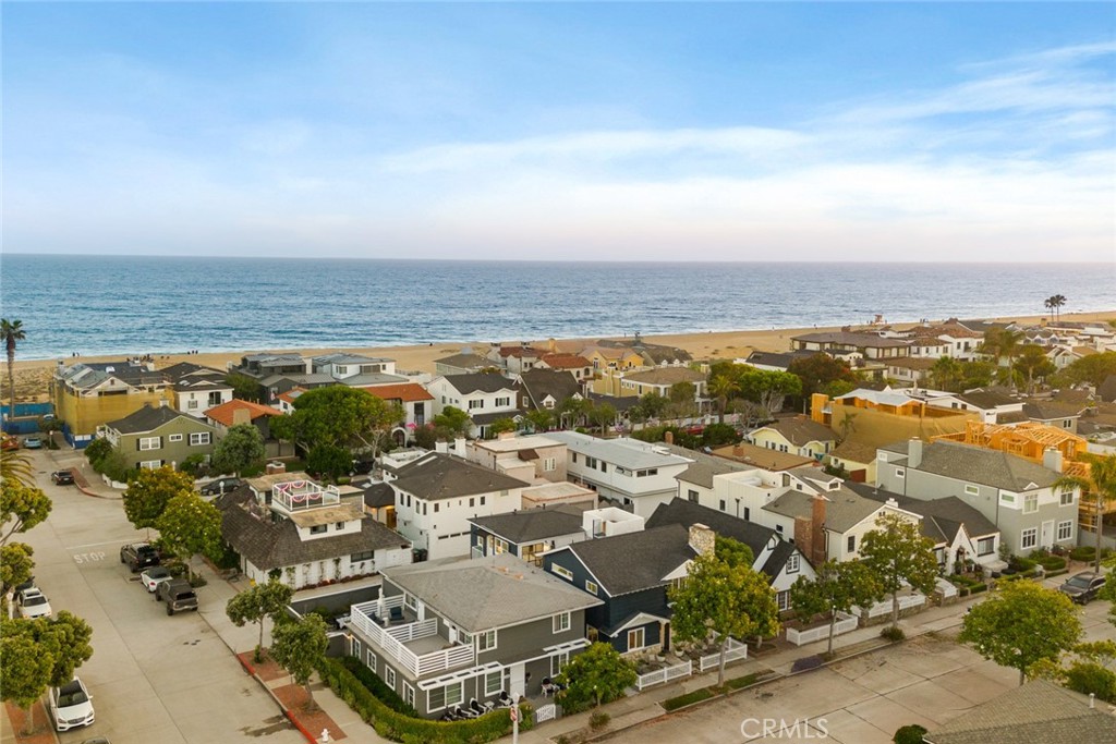 Nestled in the heart of Newport Beach’s coveted Balboa Peninsula, just two blocks from beaches along the Pacific Ocean and nearly as close to Newport Bay, this exceptionally upgraded and remodeled home is destined to enhance your lifestyle. Stroll to fashionable cafés, restaurants, shops and galleries, or relax at home on your inviting front patio, complete with a classic white picket fence. Beyond the Dutch entry door, a reimagined first level reveals open-concept style with a seamless dining room, living room and kitchen. A custom mantlepiece and white stone hearth grace a corner fireplace, while the new kitchen opens to the dining room with a passthrough bar and hosts Shaker cabinetry, stainless appliances, quartz countertops and a door to the side yard. Elegant craftsmanship is revealed through the inclusion of crown molding, wide white oak-inspired luxury vinyl plank flooring, designer lighting fixtures and custom wall treatments. Approximately 2,630 square feet, the four-bedroom, three-bath residence continues indoor/outdoor living on the second level, where a private deck is accessed by a versatile den, the primary suite and a secondary bedroom with separate entrance, making it perfect for guests. A spiral staircase leads from the main deck to a sunny rooftop deck with panoramic city-light views, and both decks are finished with slotted wood flooring. The primary suite showcases a sitting area, wood-finished accent wall, a romantic fireplace with floating hearth, a spacious dressing area with mirrored wardrobes, and a new custom bath with rain shower, freestanding tub and dual sinks. Further enrichments are led by recessed LED lighting, upgraded windows and sliding-glass doors that bathe interior spaces in natural light, a fresh white color palette, and an attached two-car garage. Close to The Wedge, a world-renowned surf spot, and minutes from Fashion Island, Balboa’s pier and Fun Zone, scenic parks, golf courses and luxury resorts, this turnkey home presents the ultimate mix of style, functionality and proximity to the water.