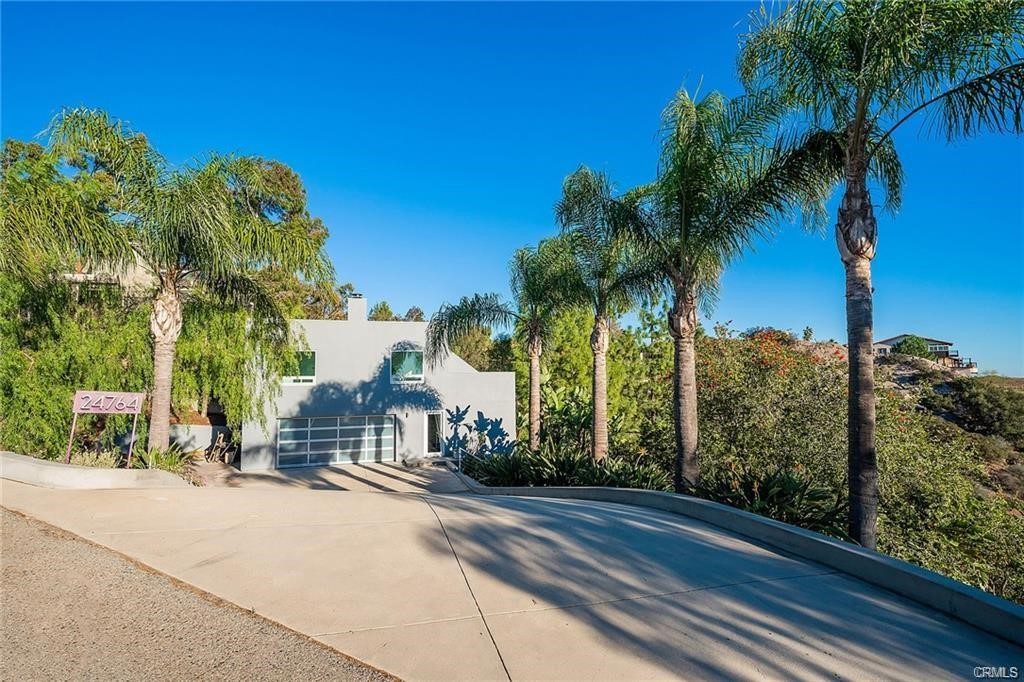 Discover your private haven, nestled behind the gates of West Saddle Peak, this stunning one-acre plus Ocean View "Pied à Terre",offers nearly 1,000 sqft of modern living available on 2 floors, and was the subject of a meticulously remodel with premium materials, in 2021. The property features mature pines and palm trees. The extensive balcony allows you to enjoy outdoor dining, from sunrise to sunset, with fabulous views from every room. The main 4,063 sqft house was destroyed by fire, leaving the guest house totally unscathed. The original plans for the house are available, and will come with the sale for quick approval to rebuild, or enjoy the property as is, with tremendous upside. Owner can carry.