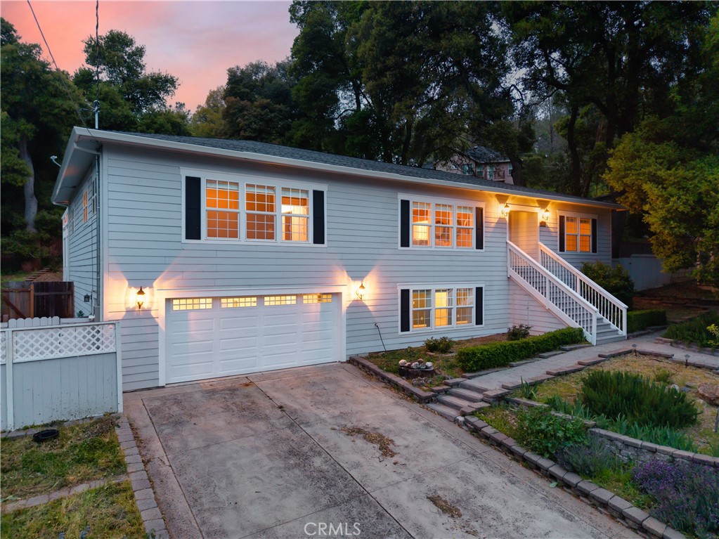 Nestled at the base of Mnt Konocti, this beautifully designed home offers the perfect blend of style and modern living. Located on a quiet street, the bright open floor plan is complemented by wood floors that flow seamlessly throughout. The spacious living and dining areas effortlessly lead into a large chef's kitchen, which is a chefs dream with tons of storage, counter top space, stainless appliances, double ovens, wine fridge, warming drawers, and a large island creating an ideal balance of elegance and functionality. The home features 3 bedrooms and 3.5 bathrooms. Offering not one, but two main level primary suites, the main including an oversized walk in closet, patio access and an elegantly designed ensuite bath, complete with a jetted soaking tub, separate glass-enclosed shower, and heated tile floors. Every door opens to a private backyard oasis, where lush greenery and serene outdoor spaces, create the perfect setting for relaxation and entertaining. . Downstairs you will find the additional 1400sqft of living space with a full bath and partial kitchen, perfect for an in law suite, home gym, theater, additional bedrooms, as well as offering a workshop space, and cold storage. An ideal turn key property in one of Lake County's most desirable neighborhoods. Enjoy your weekends on the boat, on the golf course, hiking, and fishing all while being less than 15 minutes to shopping, dining, and entertainment.