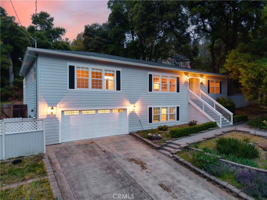 Nestled at the base of  Mnt Konocti, this beautifully designed home offers the perfect blend of style and modern living. Located on a quiet street, the bright open floor plan is complemented by wood floors that flow seamlessly throughout. The spacious living and dining areas effortlessly lead into a large chef's kitchen, which is a chefs dream with tons of storage, counter top space, stainless appliances, double ovens, wine fridge, warming drawers, and a large island creating an ideal balance of elegance and functionality. The home features 3 bedrooms and 3.5 bathrooms. Offering not one, but two main level primary suites, the main including an oversized walk in closet, patio access and an elegantly designed ensuite bath, complete with a jetted soaking tub, separate glass-enclosed shower, and heated tile floors. Every door opens to a private backyard oasis, where lush greenery and serene outdoor spaces, create the perfect setting for relaxation and entertaining. . Downstairs you will find the additional 1400sqft of living space with a full bath and partial kitchen, perfect for an in law suite, home gym, theater, additional bedrooms, as well as offering a workshop space, and cold storage. An ideal turn key property in one of Lake County's most desirable neighborhoods. Enjoy your weekends on the boat, on the golf course, hiking, and fishing all while being less than 15 minutes to shopping, dining, and entertainment.