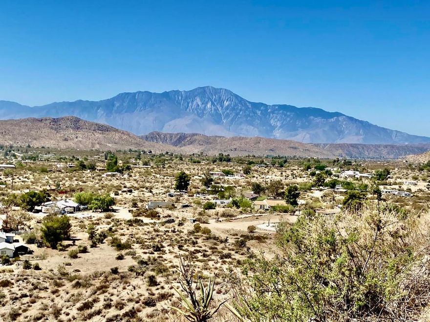Beautiful & Panoramic 5 acres perched across a breathtaking hilltop ridge. Spectacular views of snow caps on Mt San Jacinto and the little San Bernardino Mtn range. A driveway easement ascends over 100ft to the building pads. Possibilities of a multi-level sanctuary with several opportunities for several building areas. Gorgeous desert fauna with cholla cactus, creosotes and yuccas scattered among the rocks and boulders. This magical lot is close to thousands and thousands of wilderness acres for you to explore. Horse property. Starry nights and shimmering city lights. Higher elevation offers milder summers than the Coachella Valley which is just a short drive down the Morongo Pass. Ideal for a modern luxury compound hideaway. The county may allow for two homes and guest homes. The property appears to be RL-5 zoned lot which may allow for owners to enjoy limited camping. Utilities appear to be on Cheyenne with power and water access with the deeded easement. Seller owns mineral rights which are negotiable. 36 miles to Palm Springs. 20 miles to the Joshua Tree National Monument where about 3 million tourists visit the park annually. 45 miles to the Coachella Valley Music & Arts Festival which averages 100,000 visitors each day of the event. 114 miles to Los Angeles. Make your dreams come true. Buyers must contact the county planners for all questions on building and uses. Buyers must contact the appropriate utilities agencies for all questions on utilities. Address is a real assigned address, easement is to Cheyenne. GPS: 34.08946, -116.54871 Don't Wait! - Call Now! APN: 0581-161-06-0000